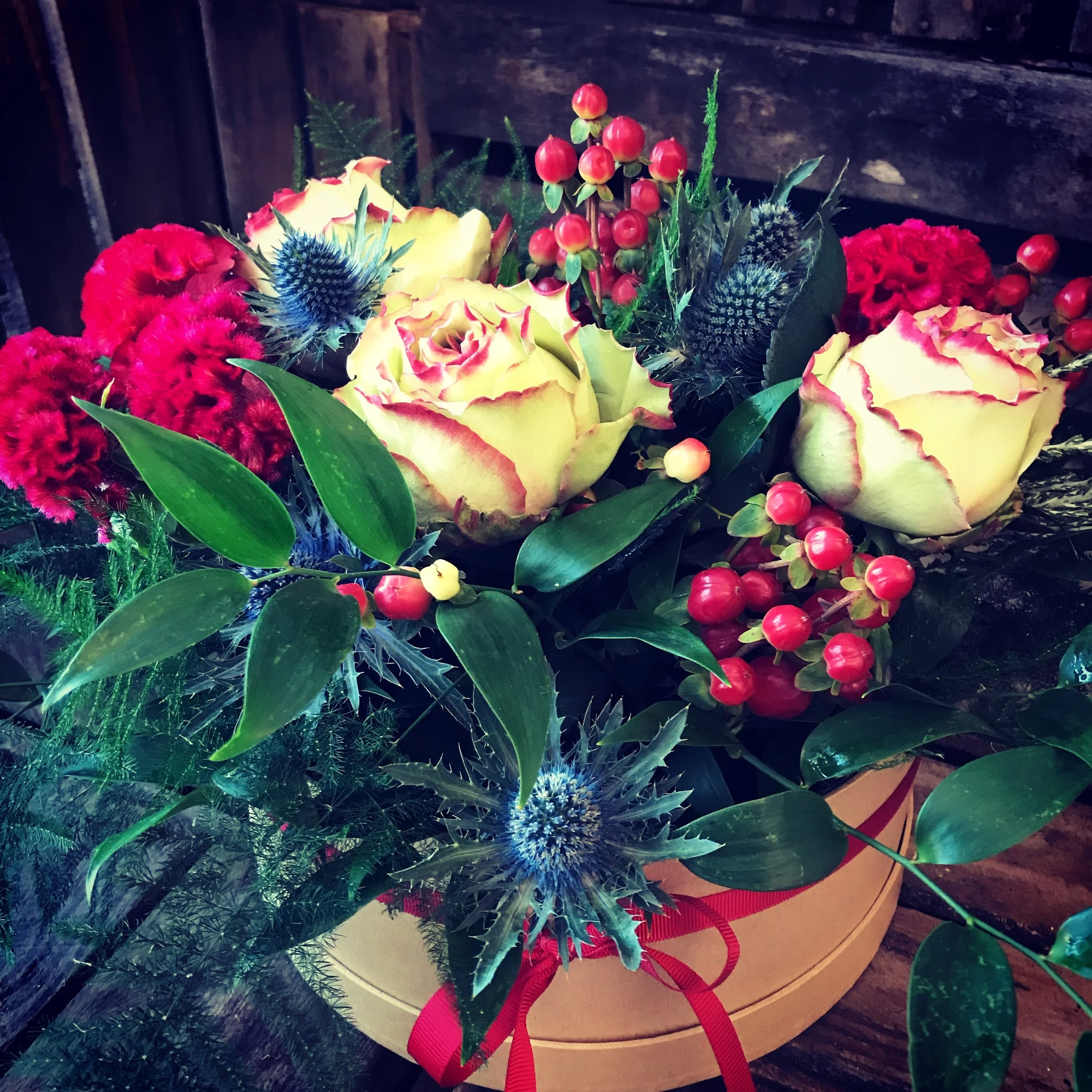 roses celosia hypericum flower arrangement in hat box
