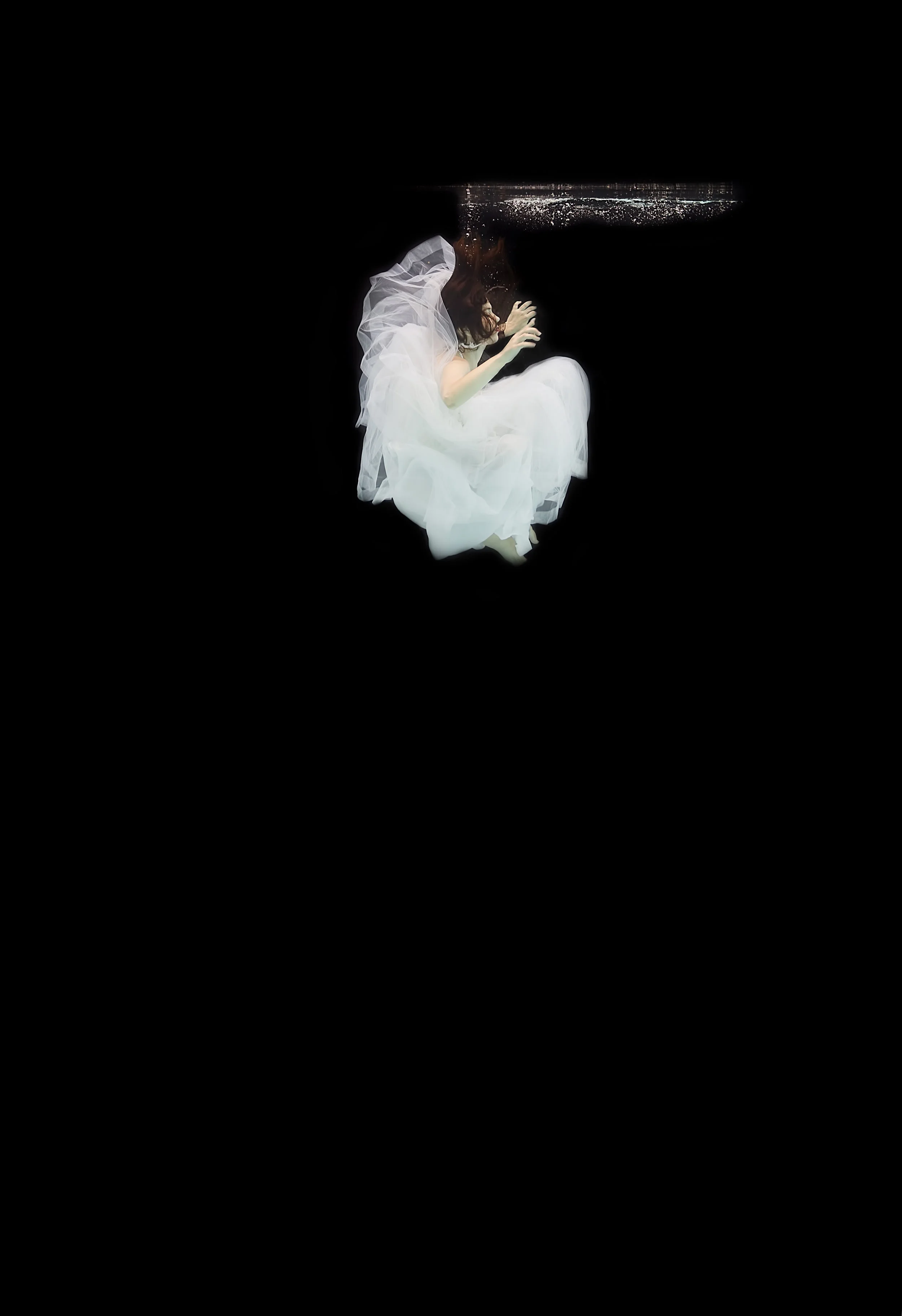 girl underwater in white dress