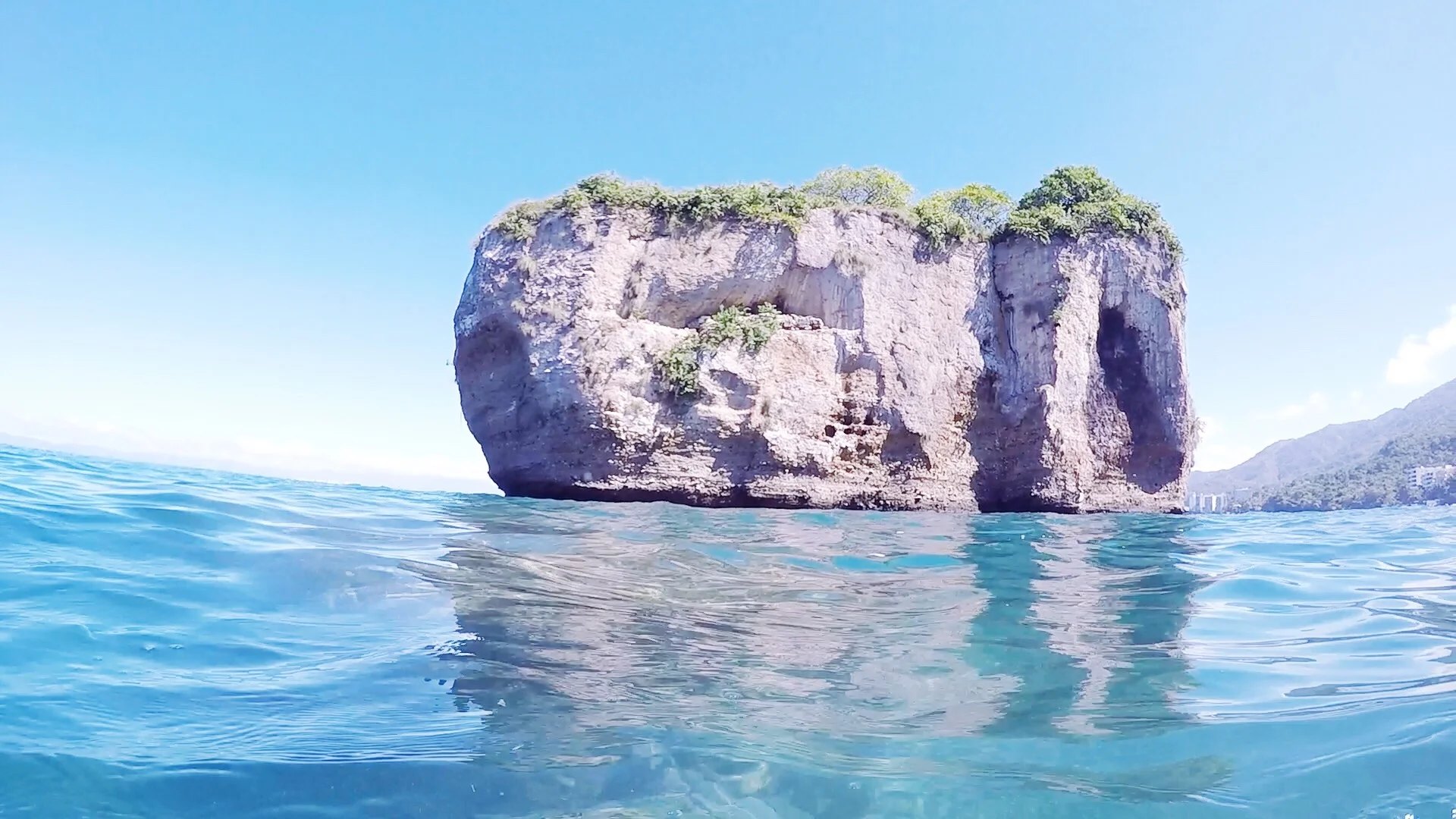 View of one of the islands of Los Arcos from the water.