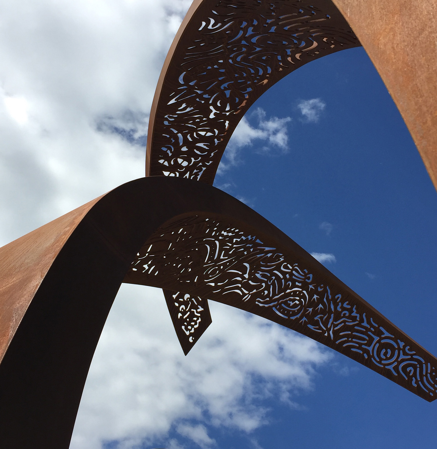 The plasma cut patterns in the top of both pieces represent some of the flora and fauna specific to the area as well as describing an aboriginal meeting place, significant to the near location of Biamanga (Mumbulla) and Gulaga Mountains. The design of the patterning was inspired by the impressions found under the bark of many local gums, which were left by Eucalyptus Long Horned Beetles.