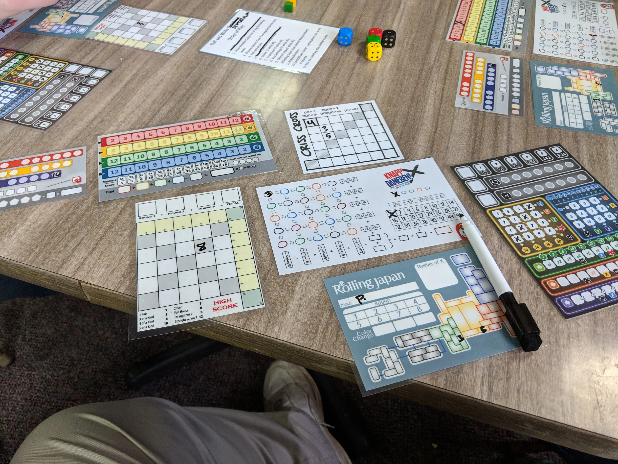 Close up of the seven roll-and-writes we played. I had played all but Wurfle Dice (middle left).