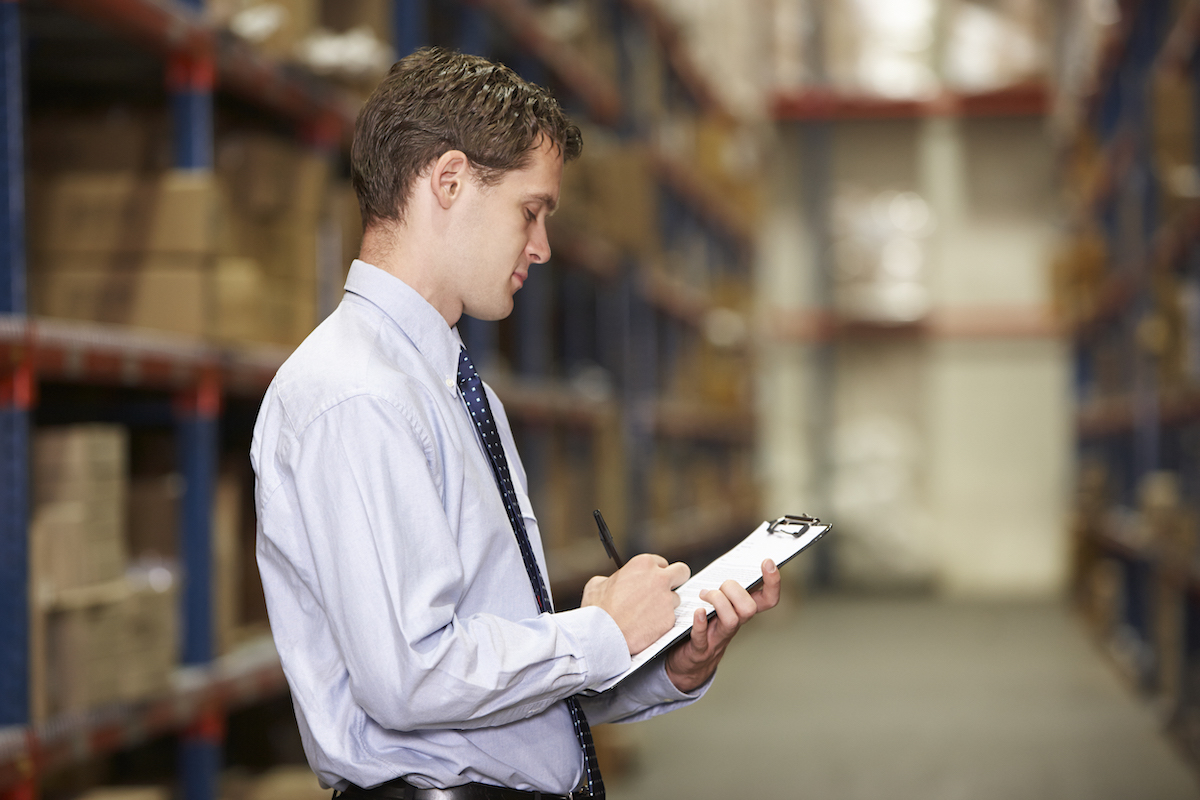 manager-in-warehouse-with-clipboard-PTQK8AH.jpg