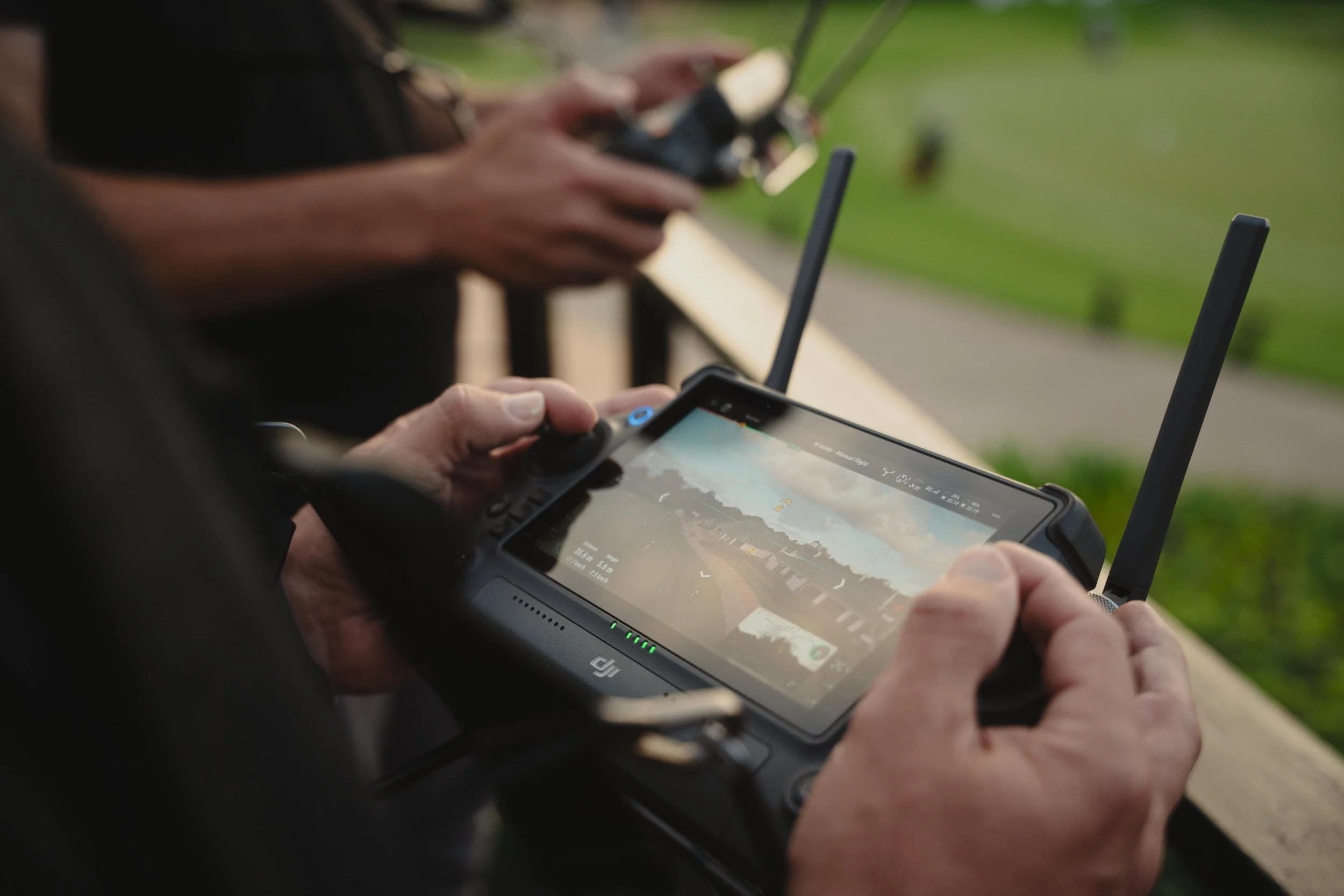 DJI Inspire 3 controller showing live aerial view of golf course