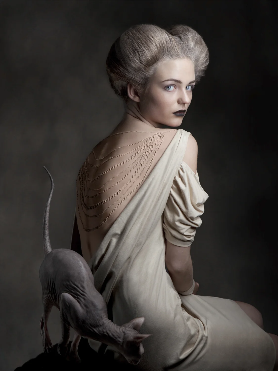 Intimacy Intimacy issues our society’s significance of beauty standards and consumption, caricaturing our willingness of mutilation to fit to an distorted ideal dictated by the media. The series shows two young, delicate women wearing jewelry implanted directly under their skin. Nude-tones dominate and support the topic, a naked sphinx cat interacts and mirrors the absurdity of the subject.