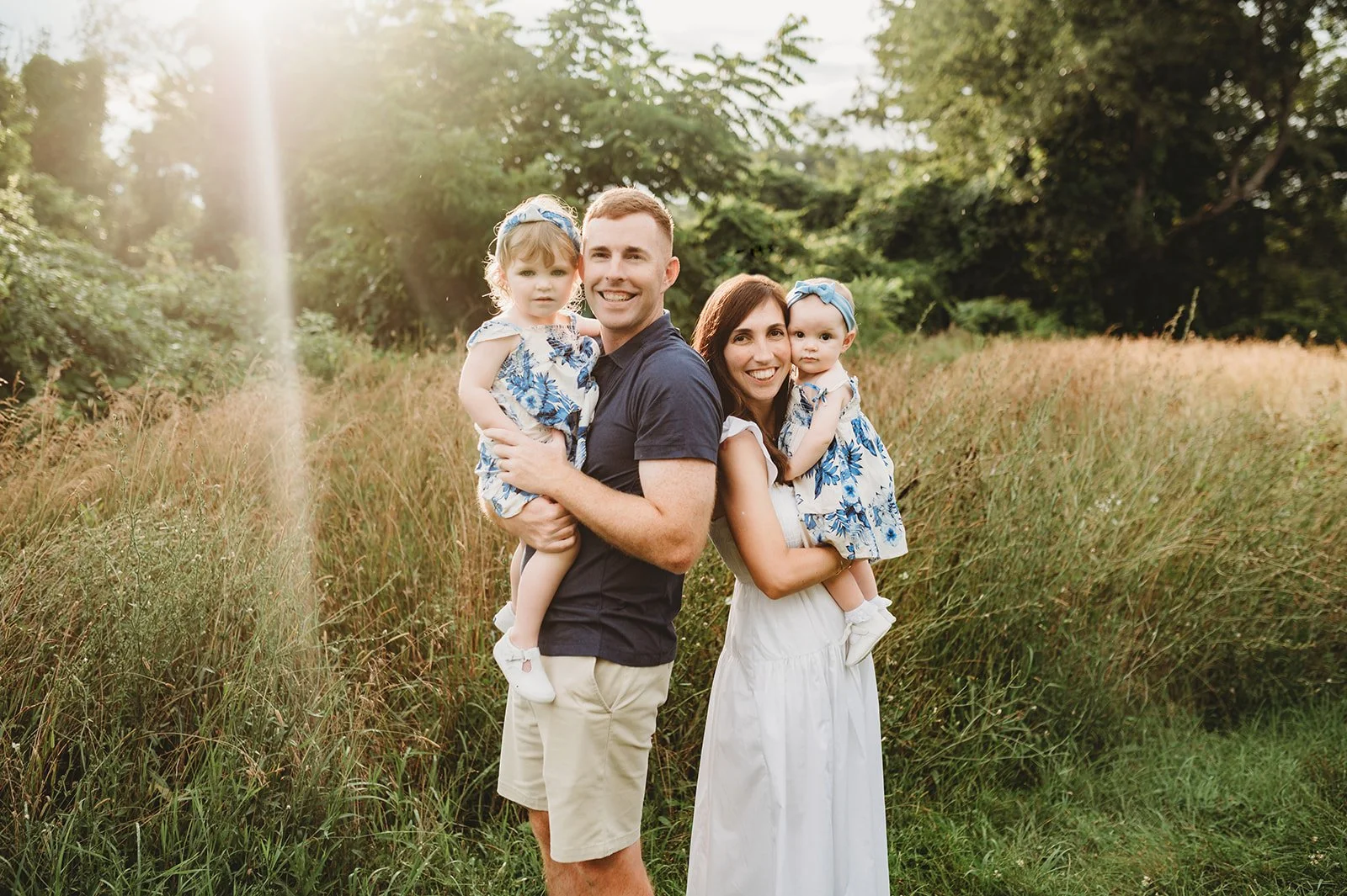 family of four stands in Westchester, ny for a photoshoot with two toddler daughters