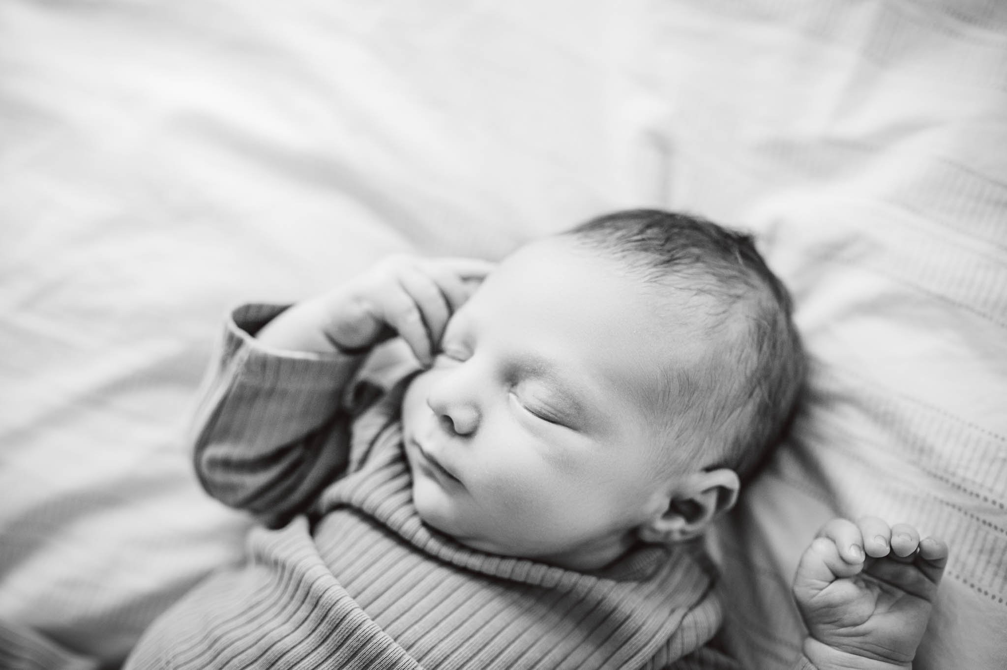 Baby lays on bed, asleep