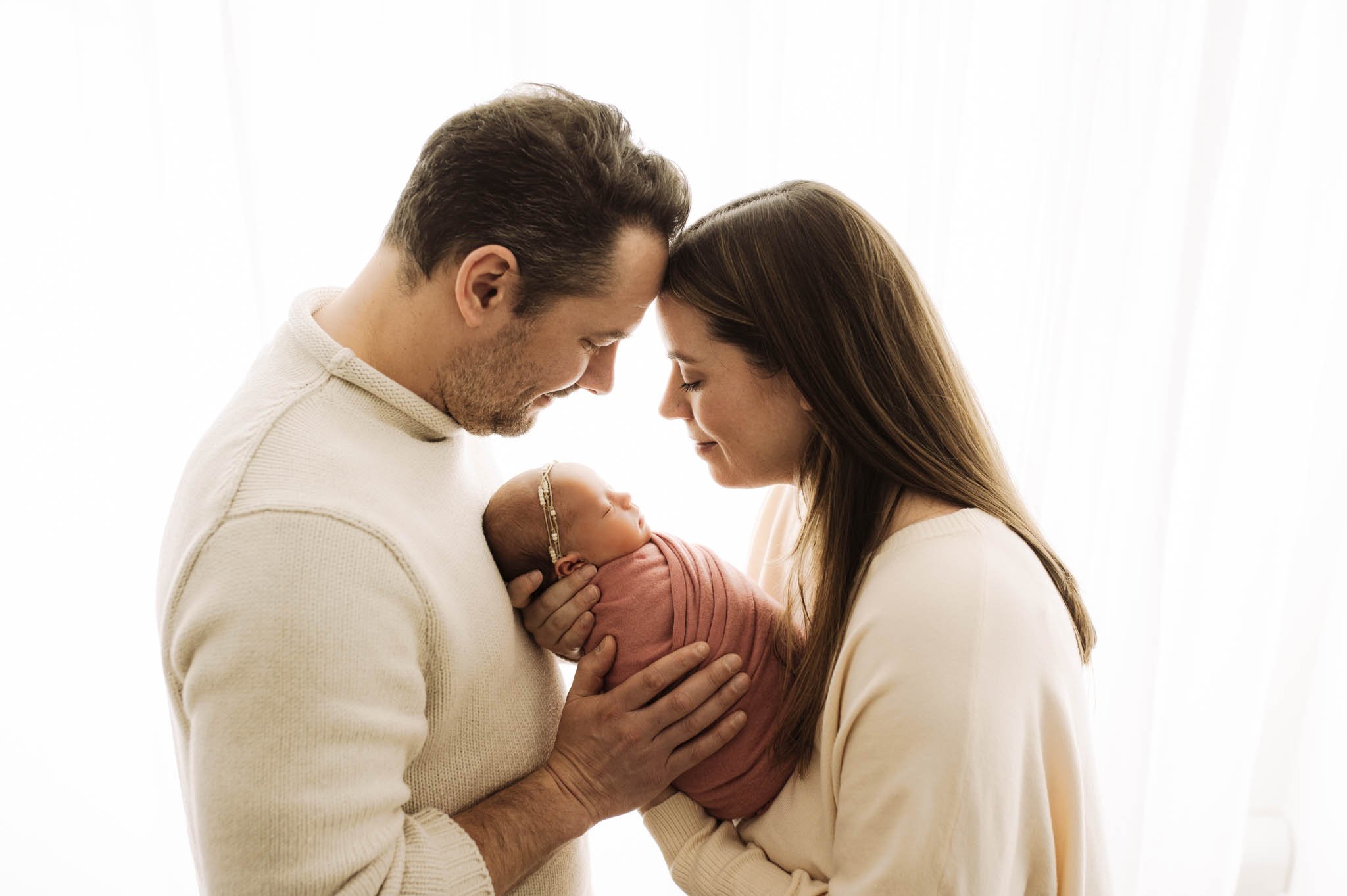 Parents and newborn baby girl in profile