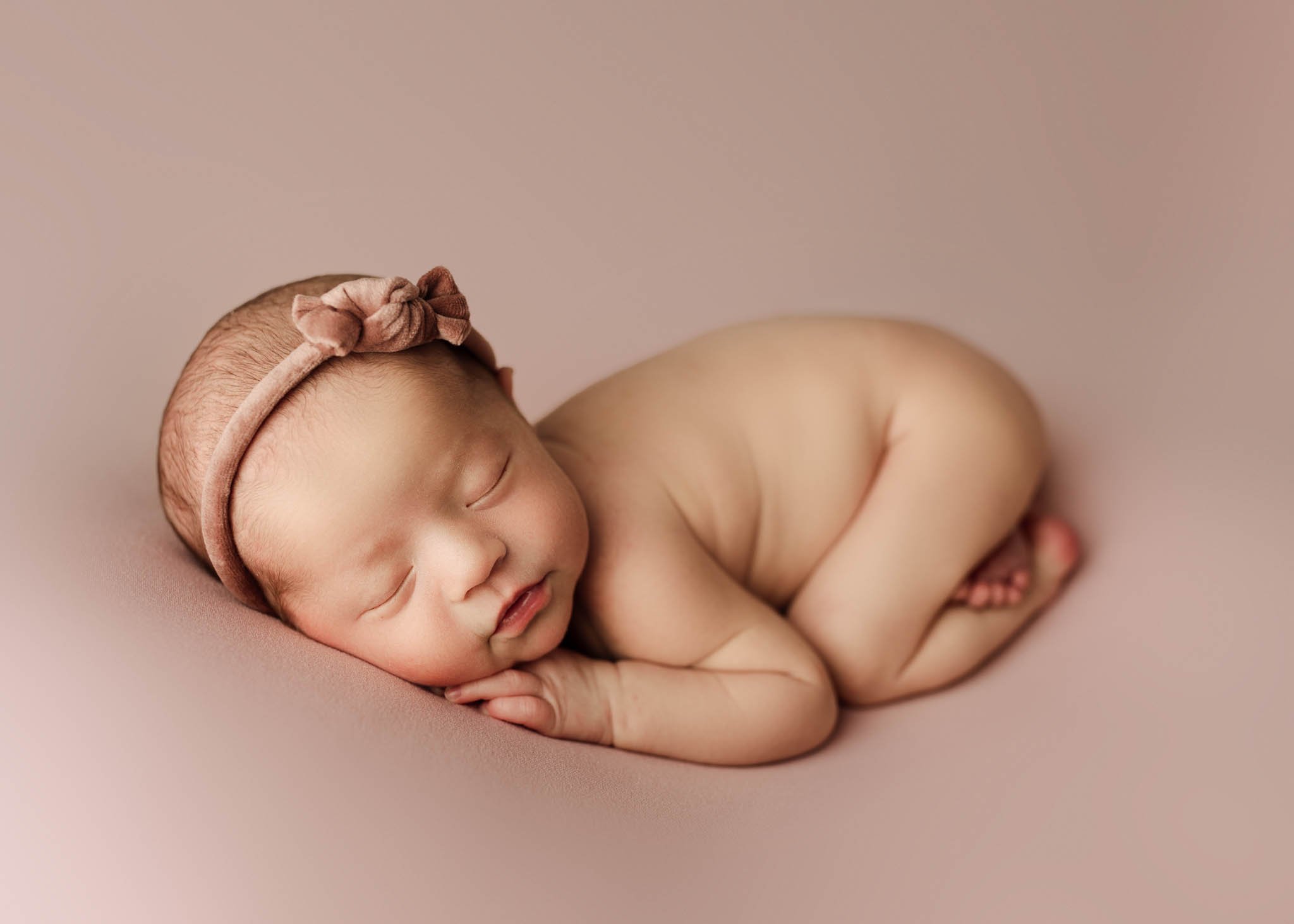 Baby girl on pink blanket, headband