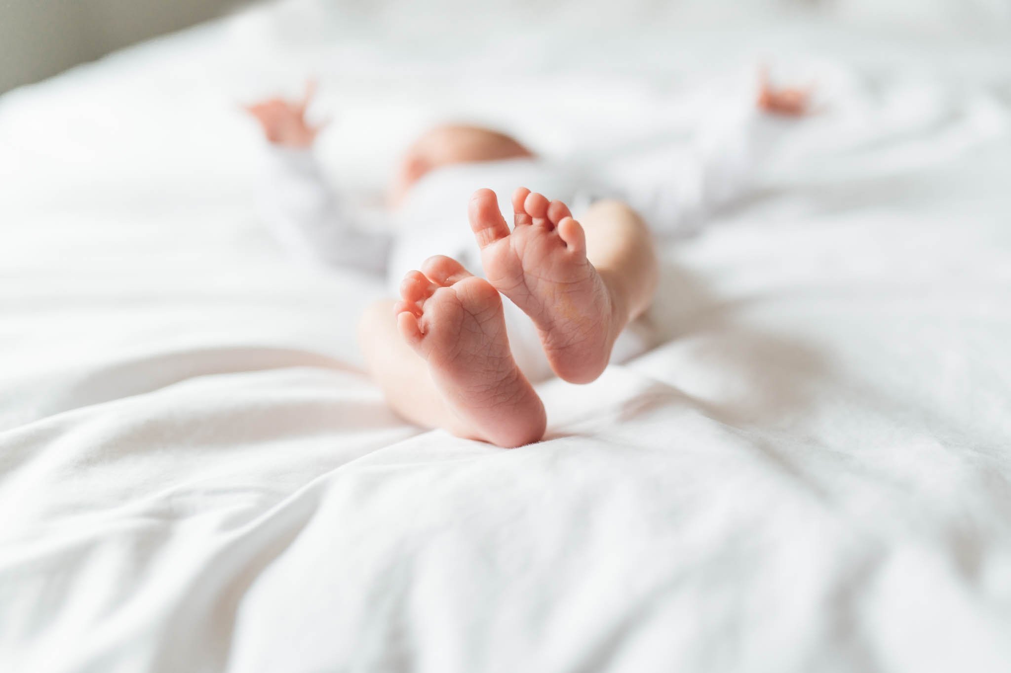 Baby feet on bed