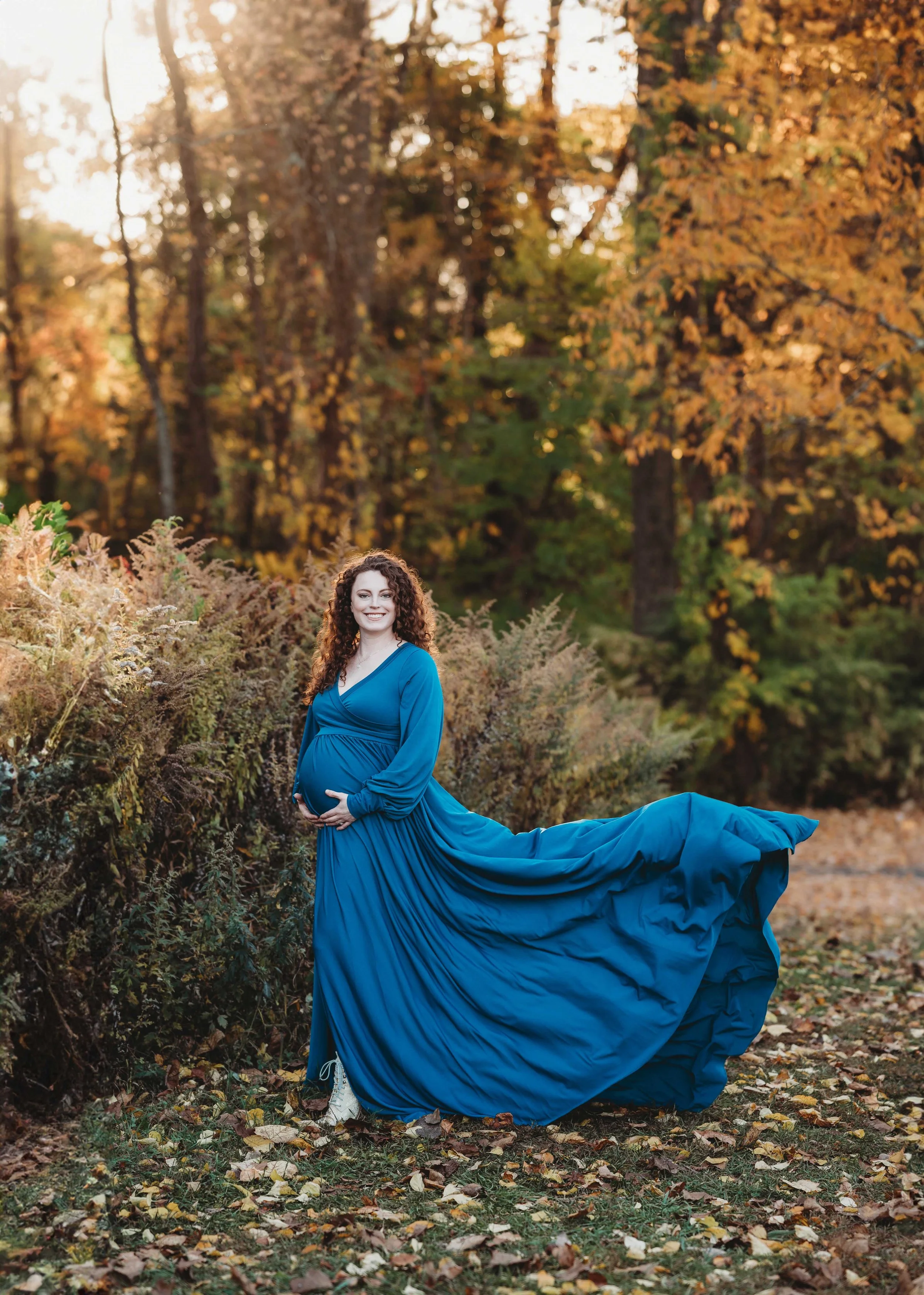 woman in flowy dress poses for her maternity photoshoot, ridgefield fall foliage