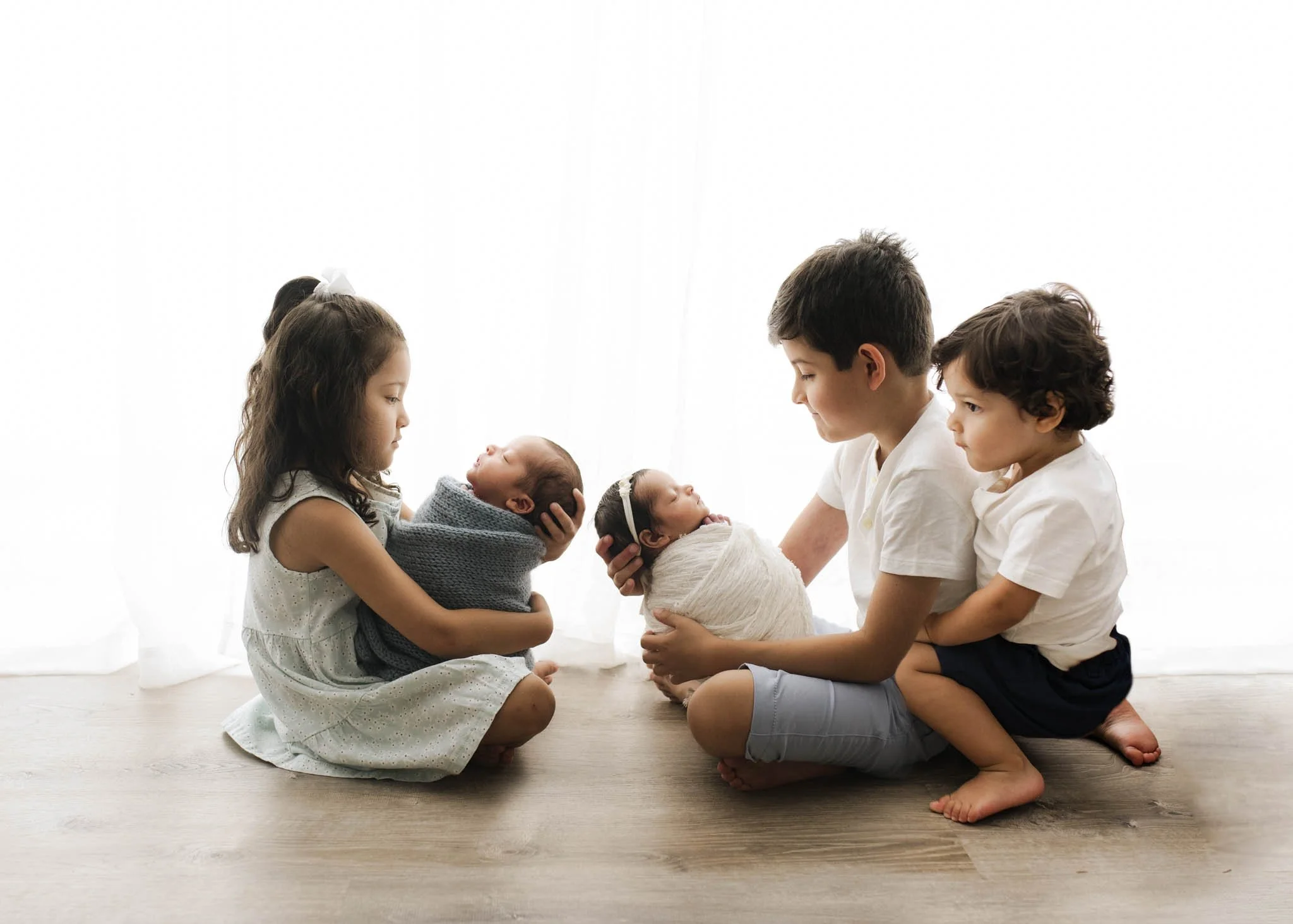 twins and their three older siblings pose in Fairfield County photography studio