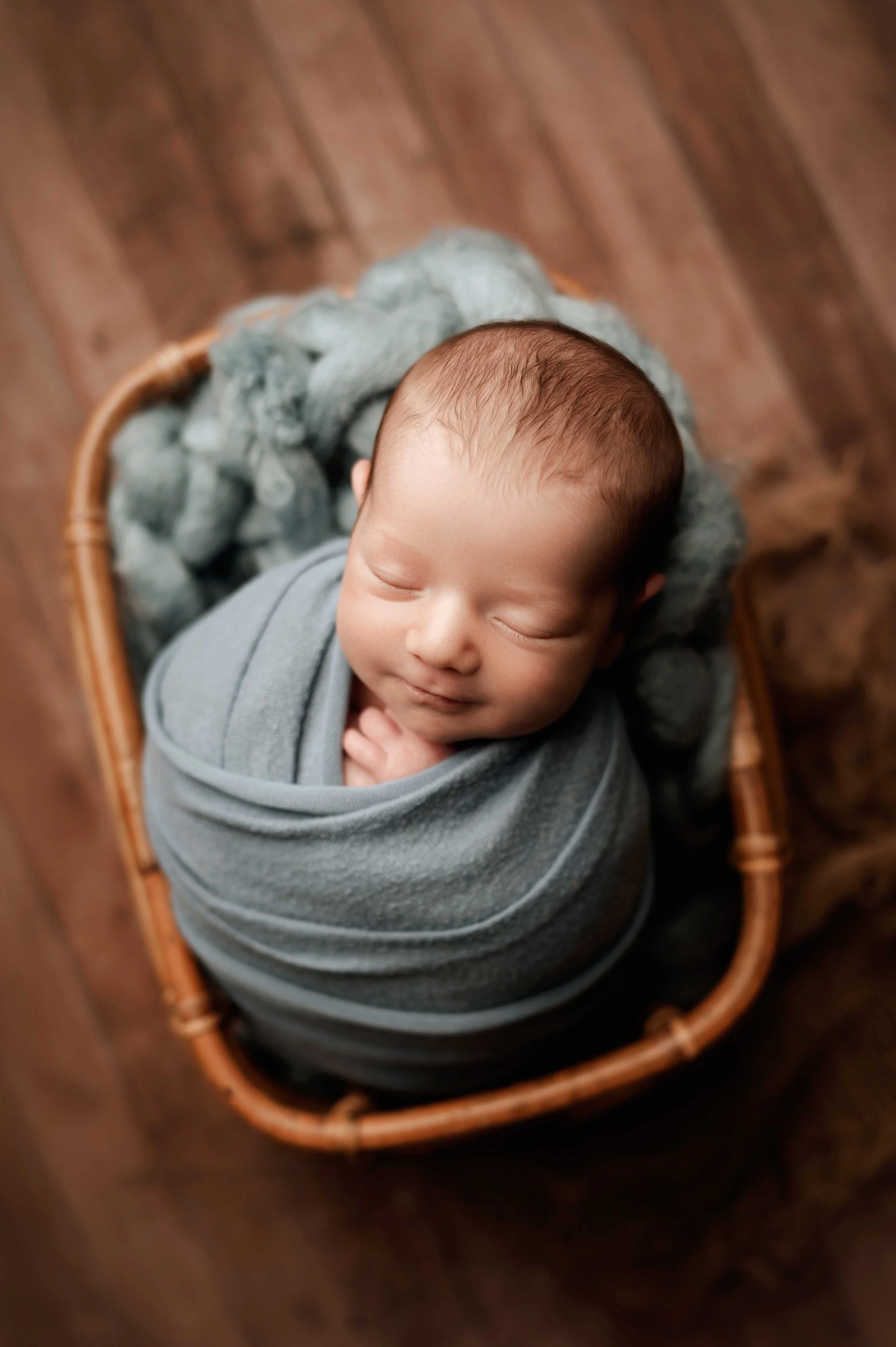 baby boy in blue blanket sleeps in basket in ridgefield, ct studio