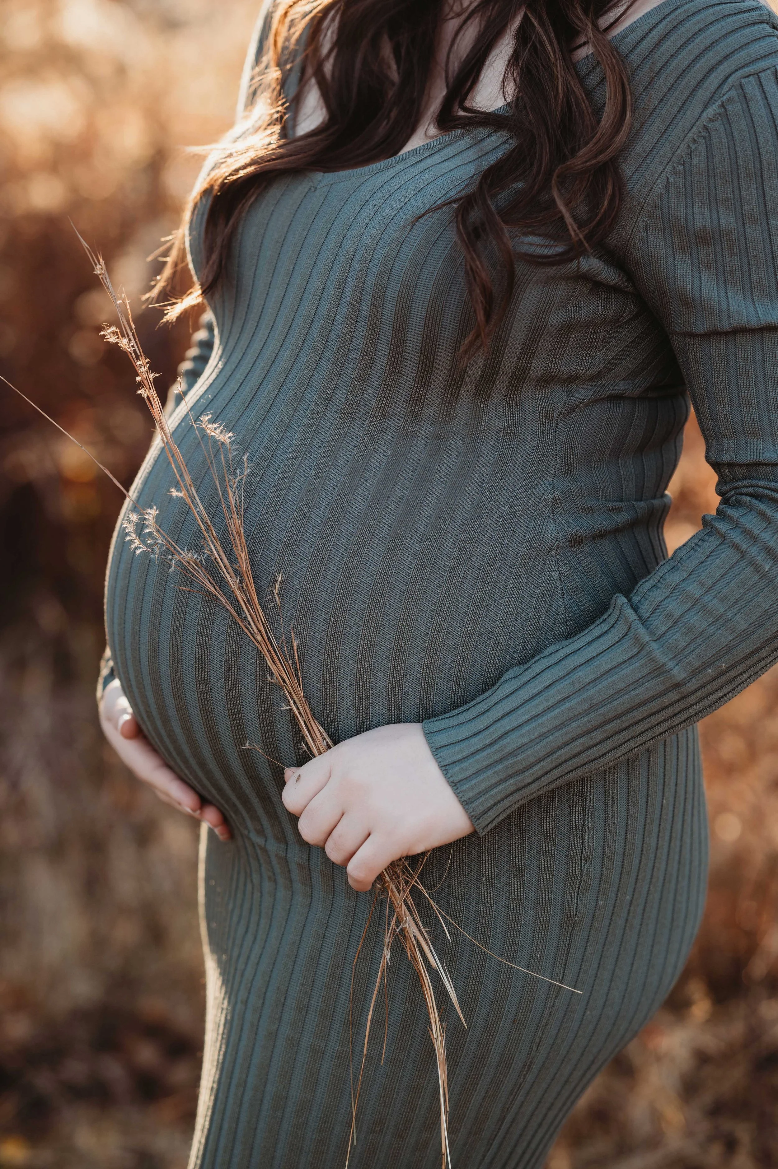closeup shot of green maternity dress in fall maternity photoshoot, wilton ct