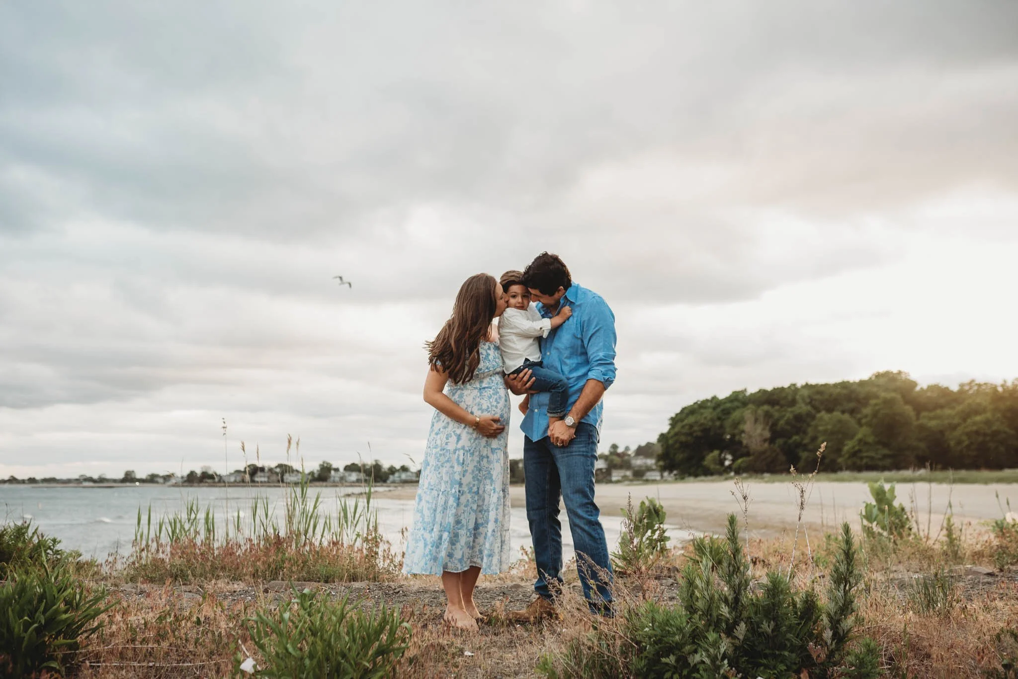expecting couple with toddler boy at their maternity beach photoshoot, fairfield county