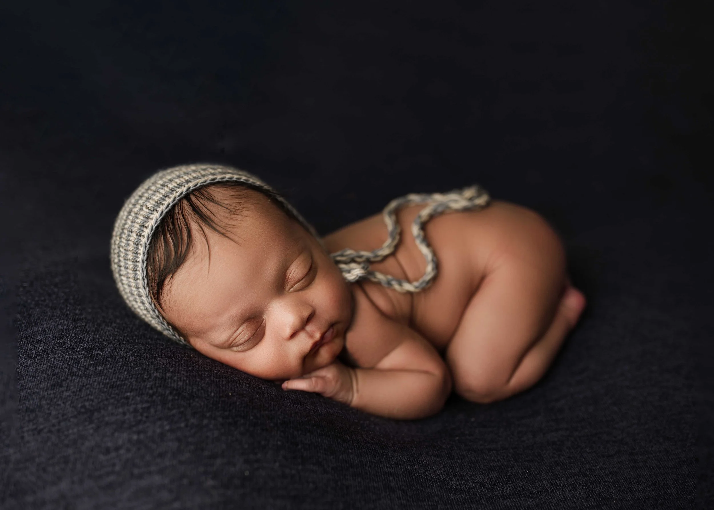 baby boy in Ridgefield, CT studio sleeps while wrapped in tan blanket