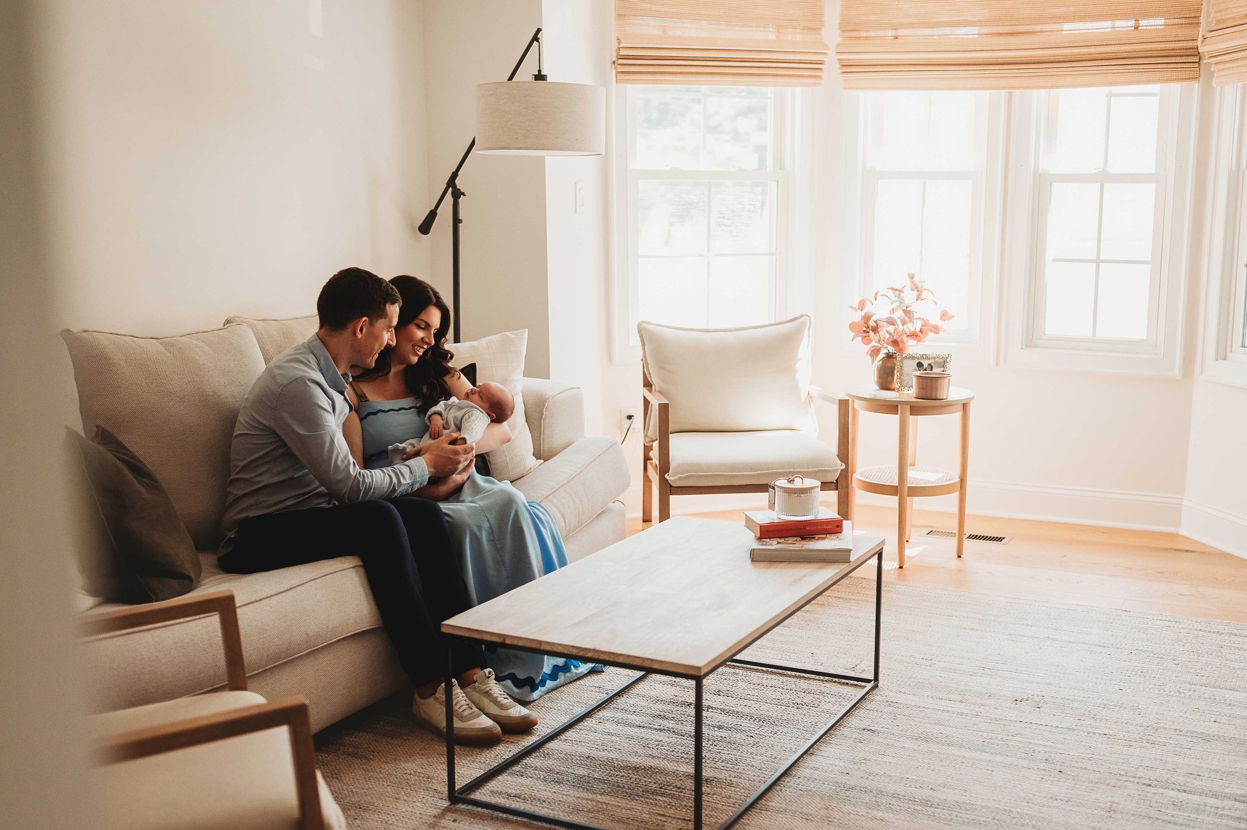 parents sit in living room with baby, lifestyle newborn session, tuckahoe, ny