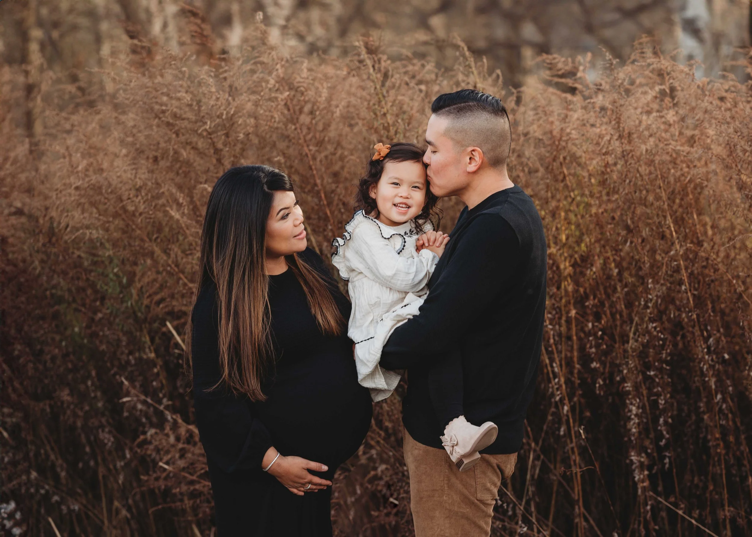 expecting couple holds toddler daughter for maternity photoshoot in westchester ny