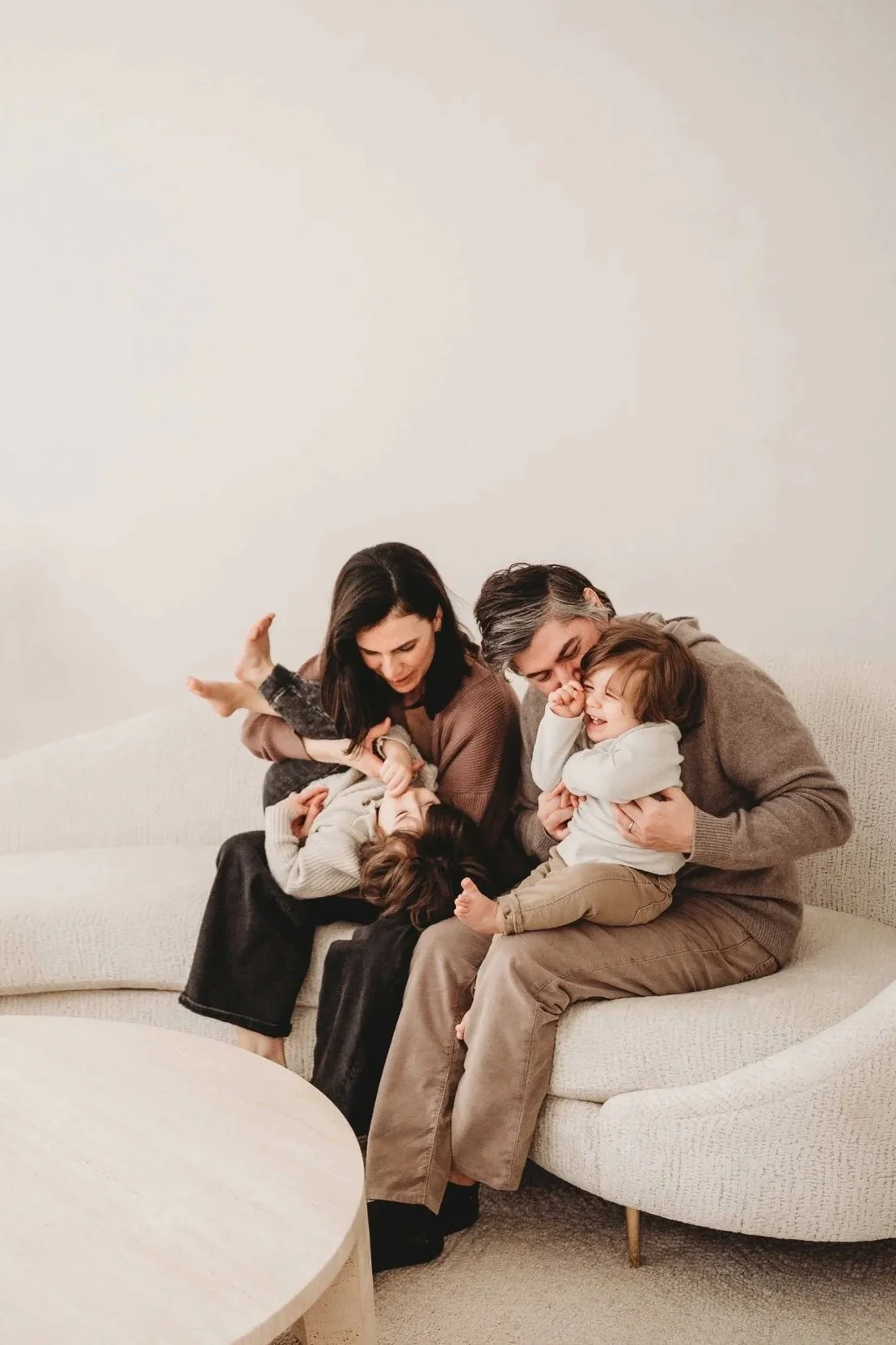 family of four snuggles on couch, lifestyle family photoshoot, chappaqua, ny 