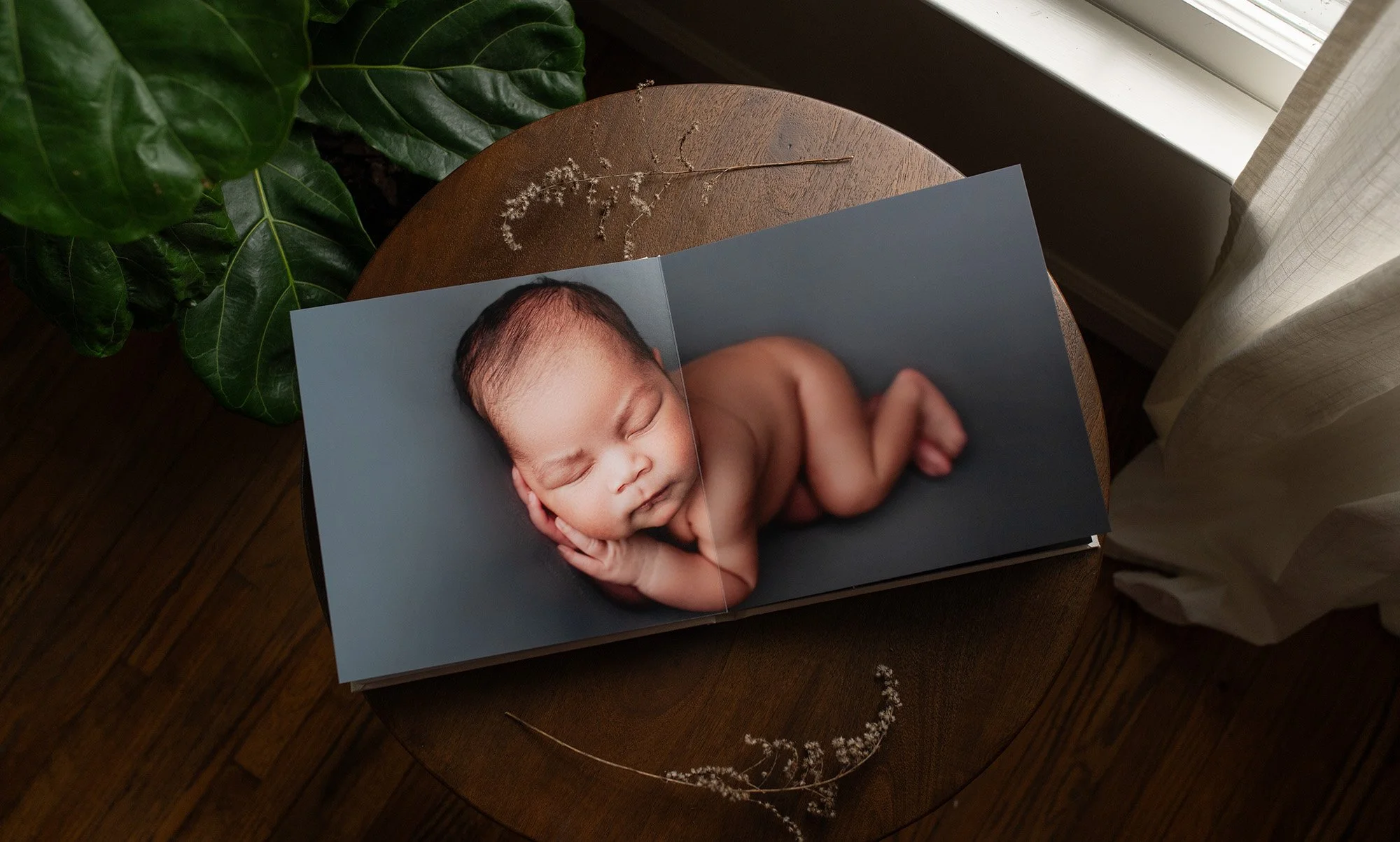 a newborn album lays open featuring a baby boy in a ridgefield, ct photography studio