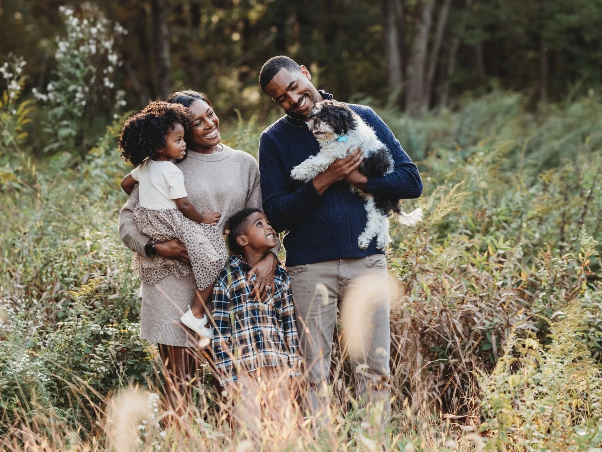 black family smiles at their down in a wilton, ct field