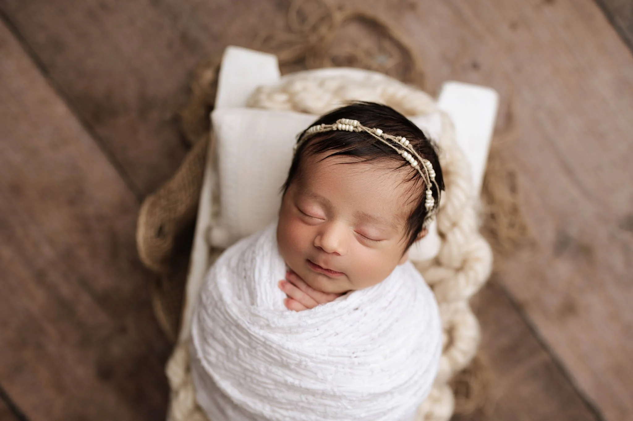 baby girl sleeps in white swaddle during ridgefield, ct studio newborn photoshoot