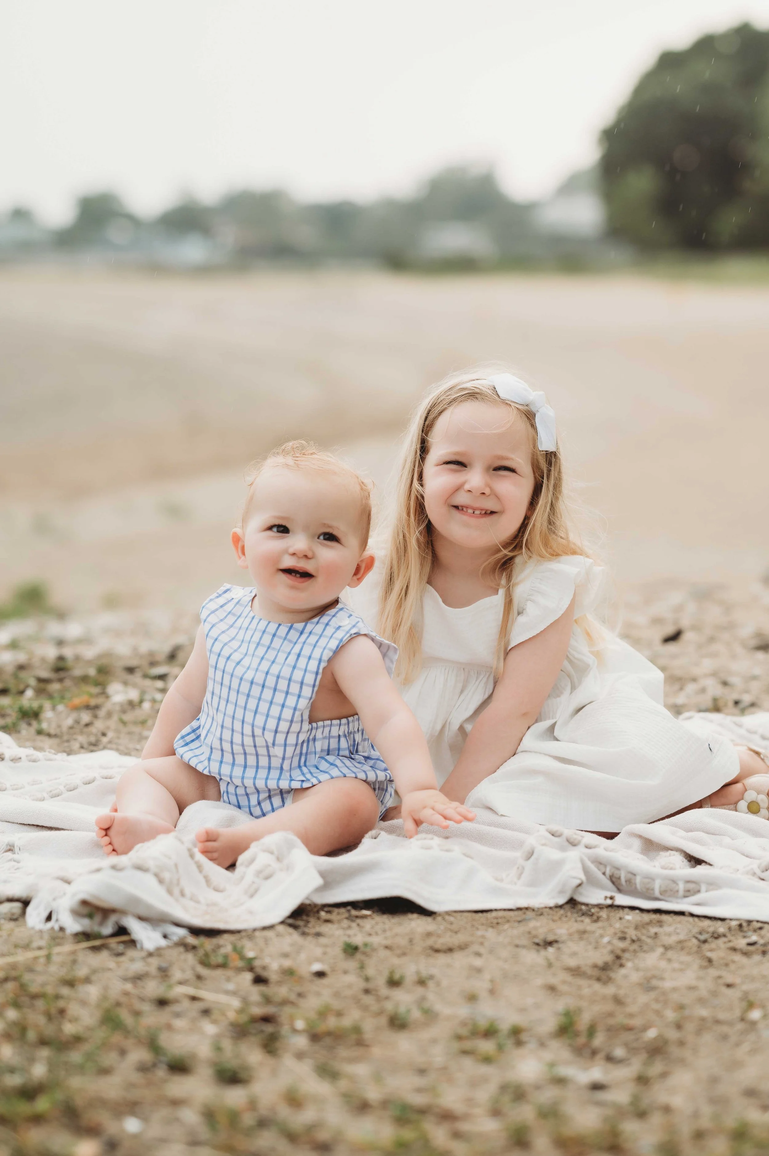 little girls sits with brother on beach for family photoshoot, Fairfield County, ct