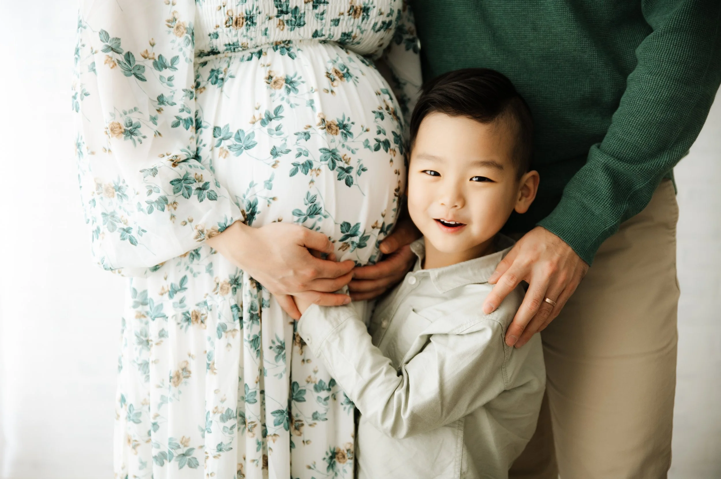 closeup shot of little boy snuggling mom's pregnant stomach, ridgefield, ct studio