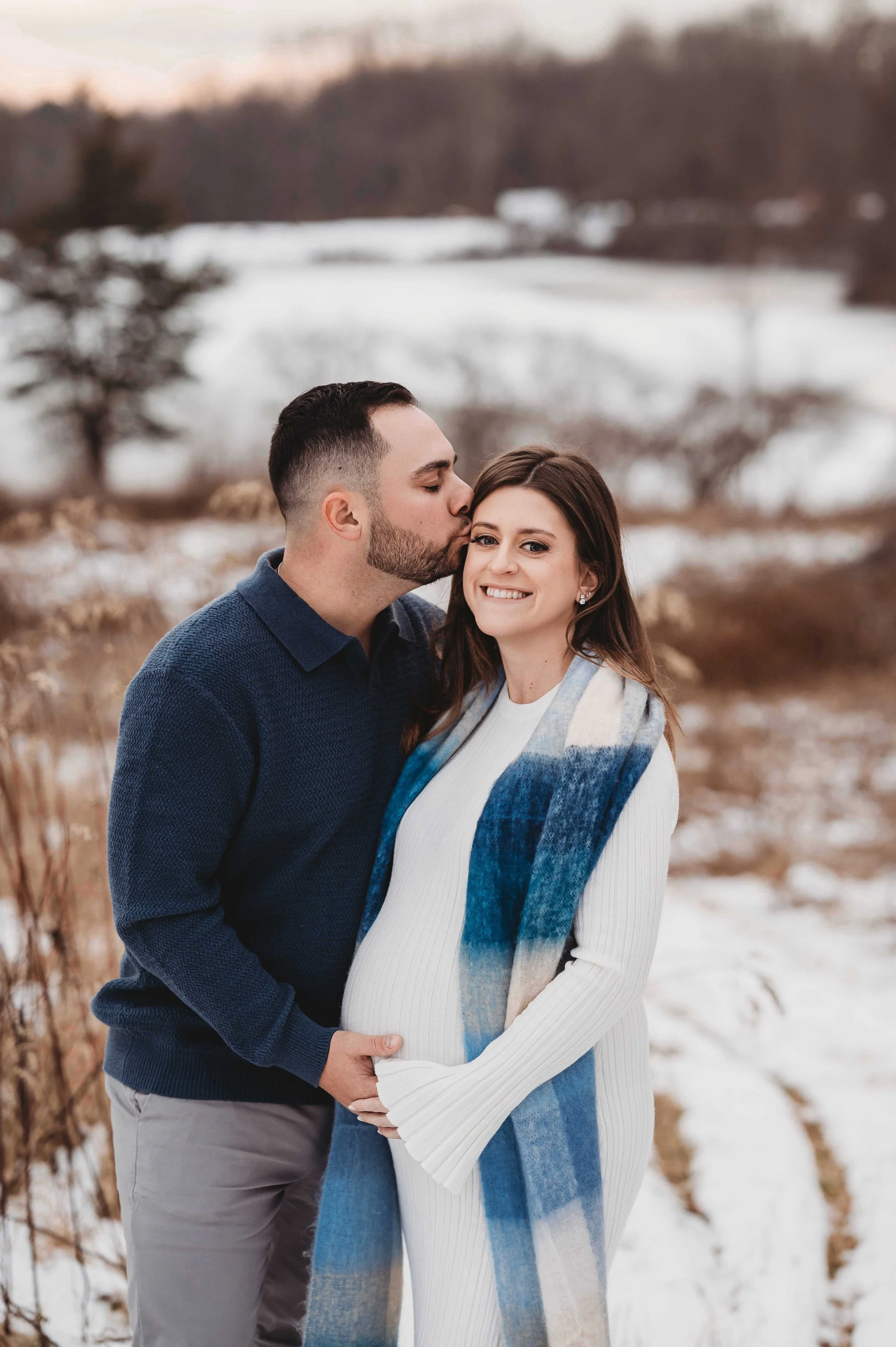 pregnant woman and husband in a winter scene in westchester, ny, maternity photoshoot