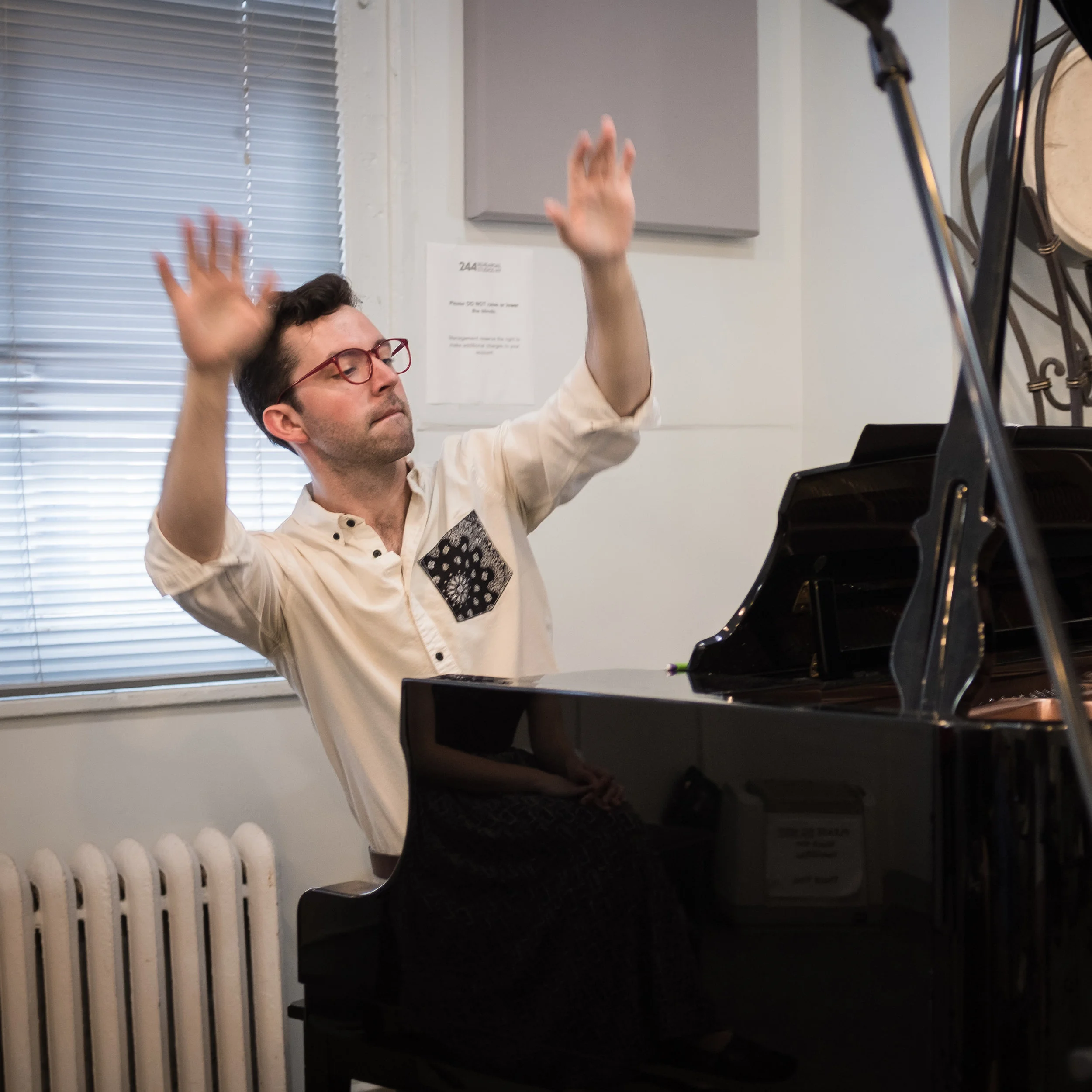 Music Director Robert Frost conducting the singers and orchestra during a recording session.