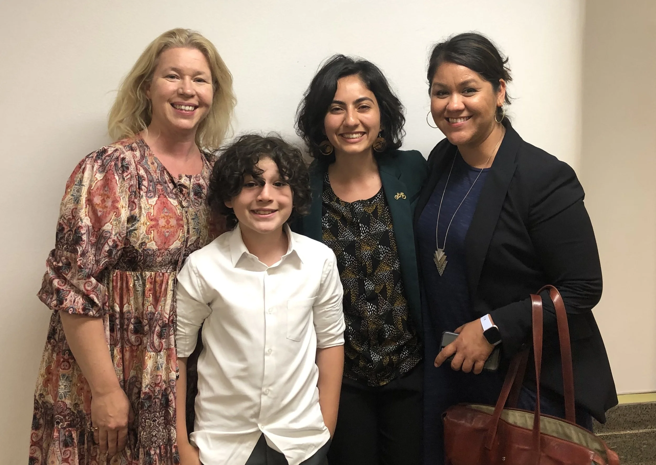 Cal Walks' Esther Rivera and CalBike's Linda Khamoushian celebrating with star witness Moses Trujillo (5th grader at Malcolm X Elementary School in Berkeley) and his mother after SB 127 passed out of the Assembly Transportation Committee.