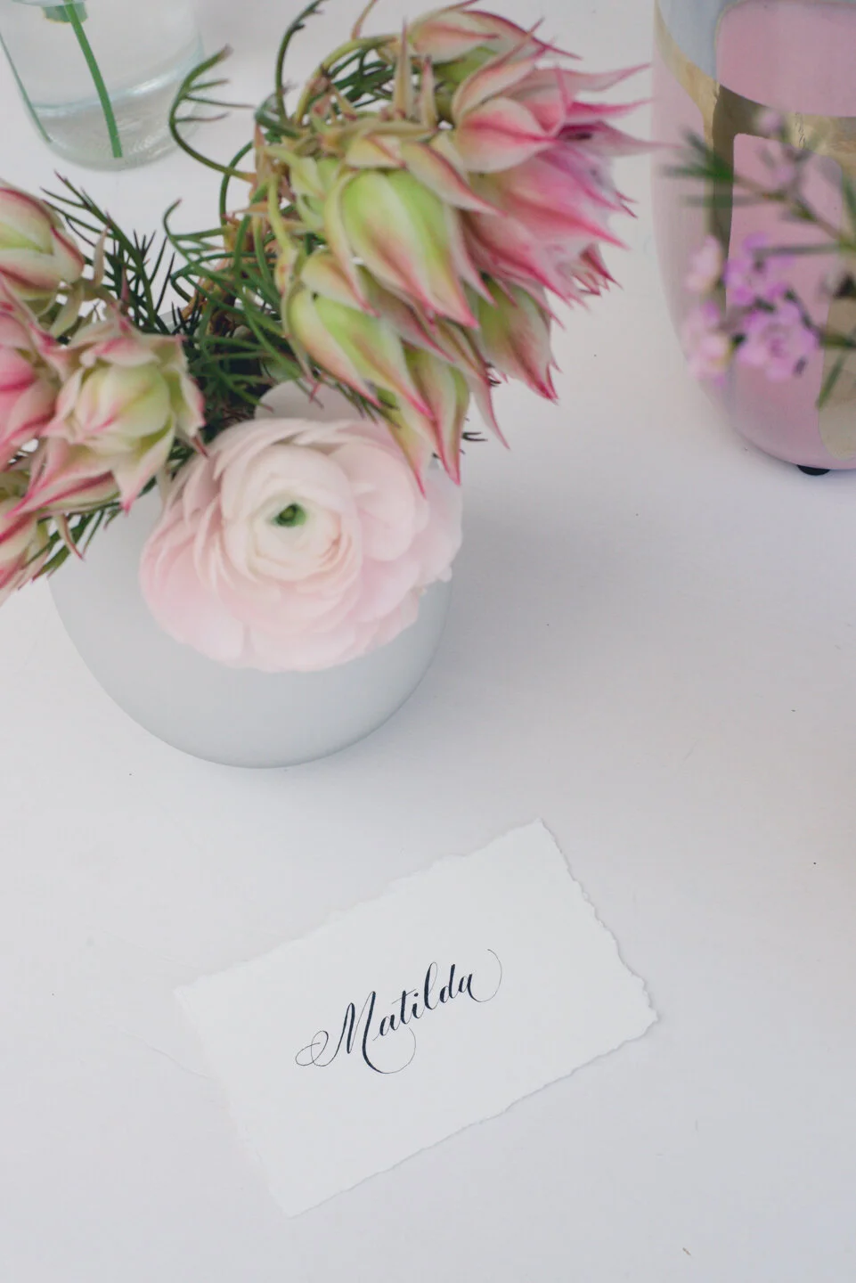 Simple white place card with Copperplate calligraphy (Patricia style).