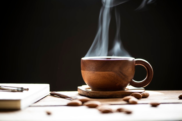 hot-tea-with-steam-wood-cup-almonds-wooden-table_107612-5.jpg