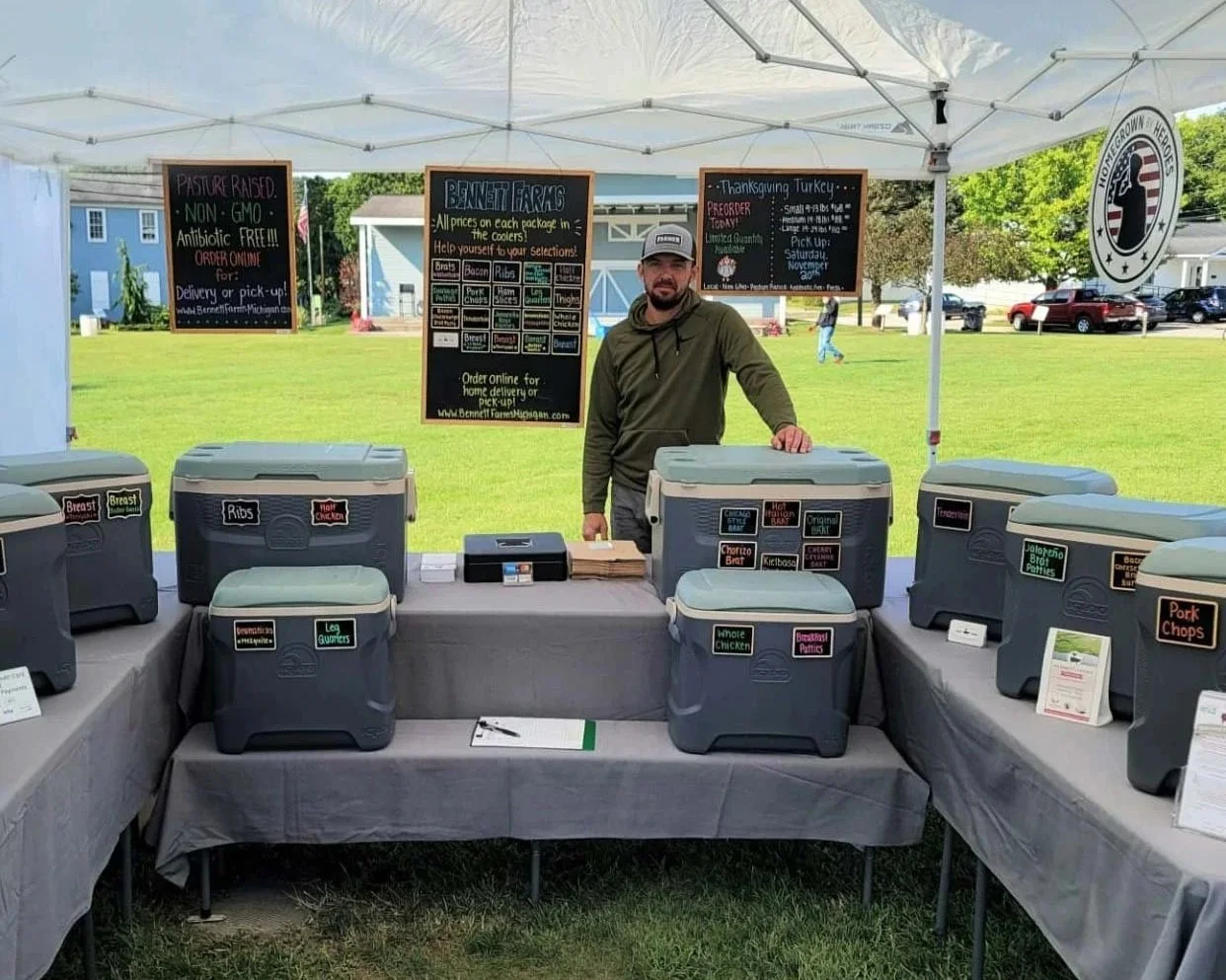 A farmer attending a local farmers market to sell his product direct to consumers