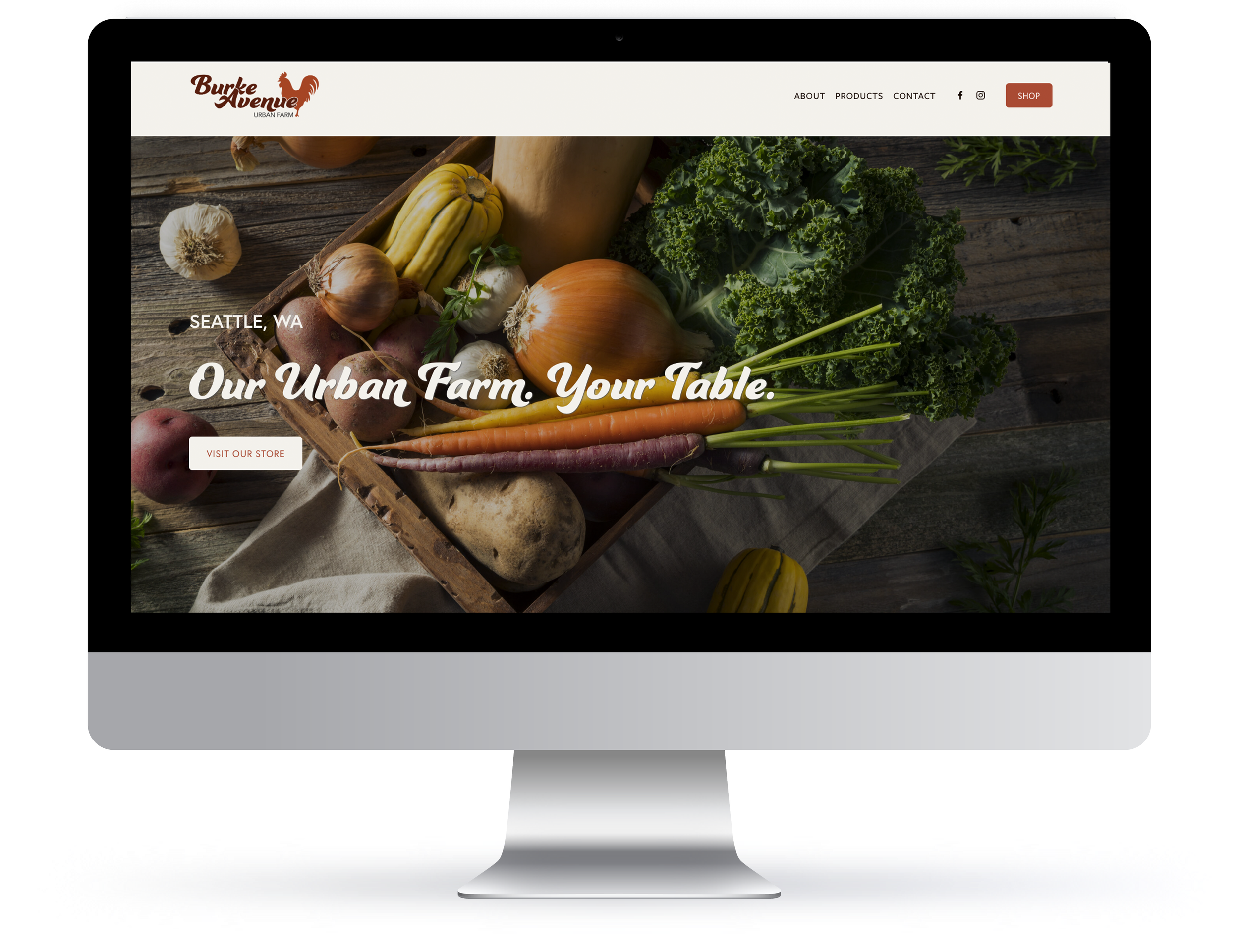 Desktop monitor displaying the Burke Avenue Urban Farm website homepage with a fresh produce flat lay and the text "Our Urban Farm. Your Table."