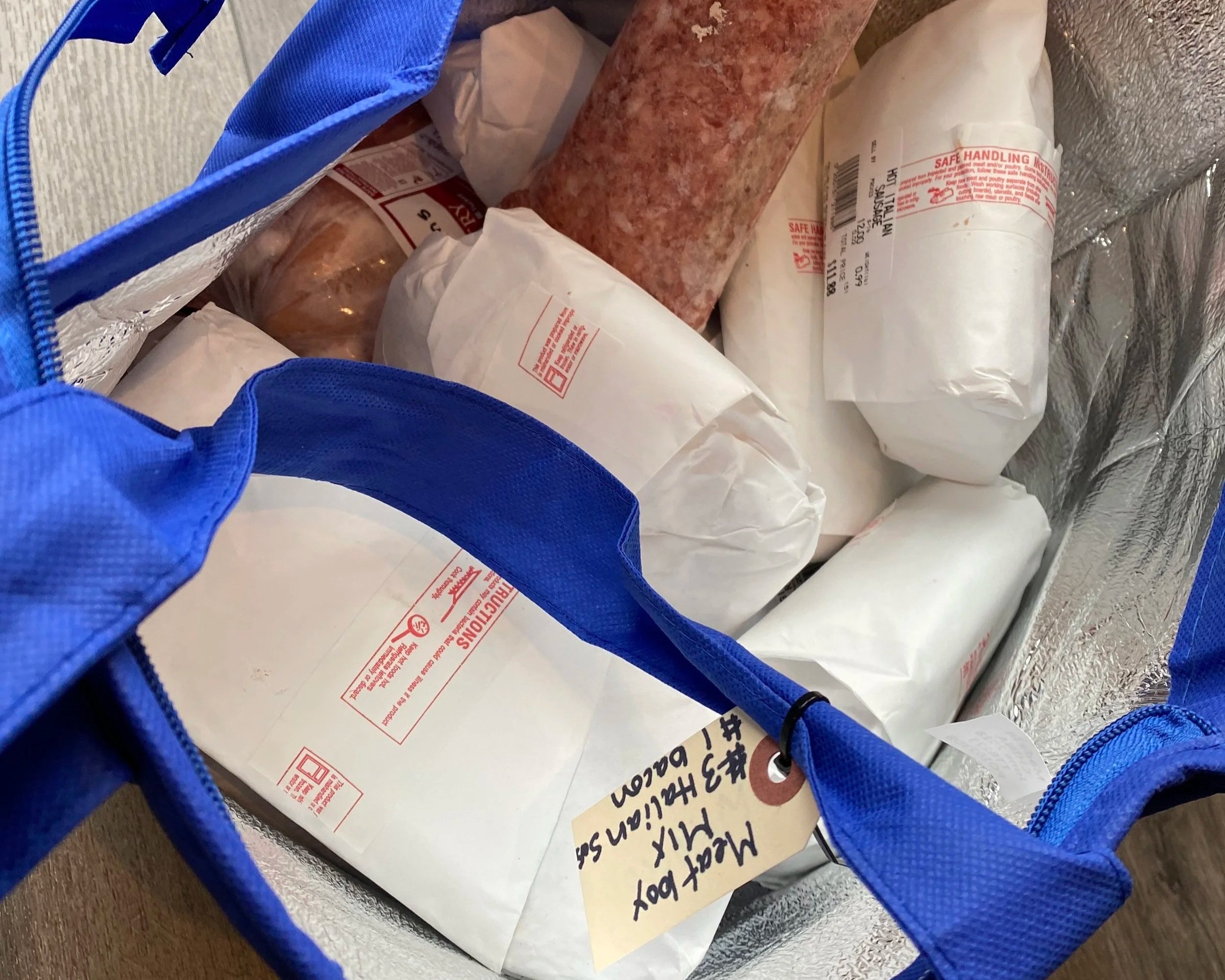 A fresh meat delivery from a local farmer packaged in an insulated bag