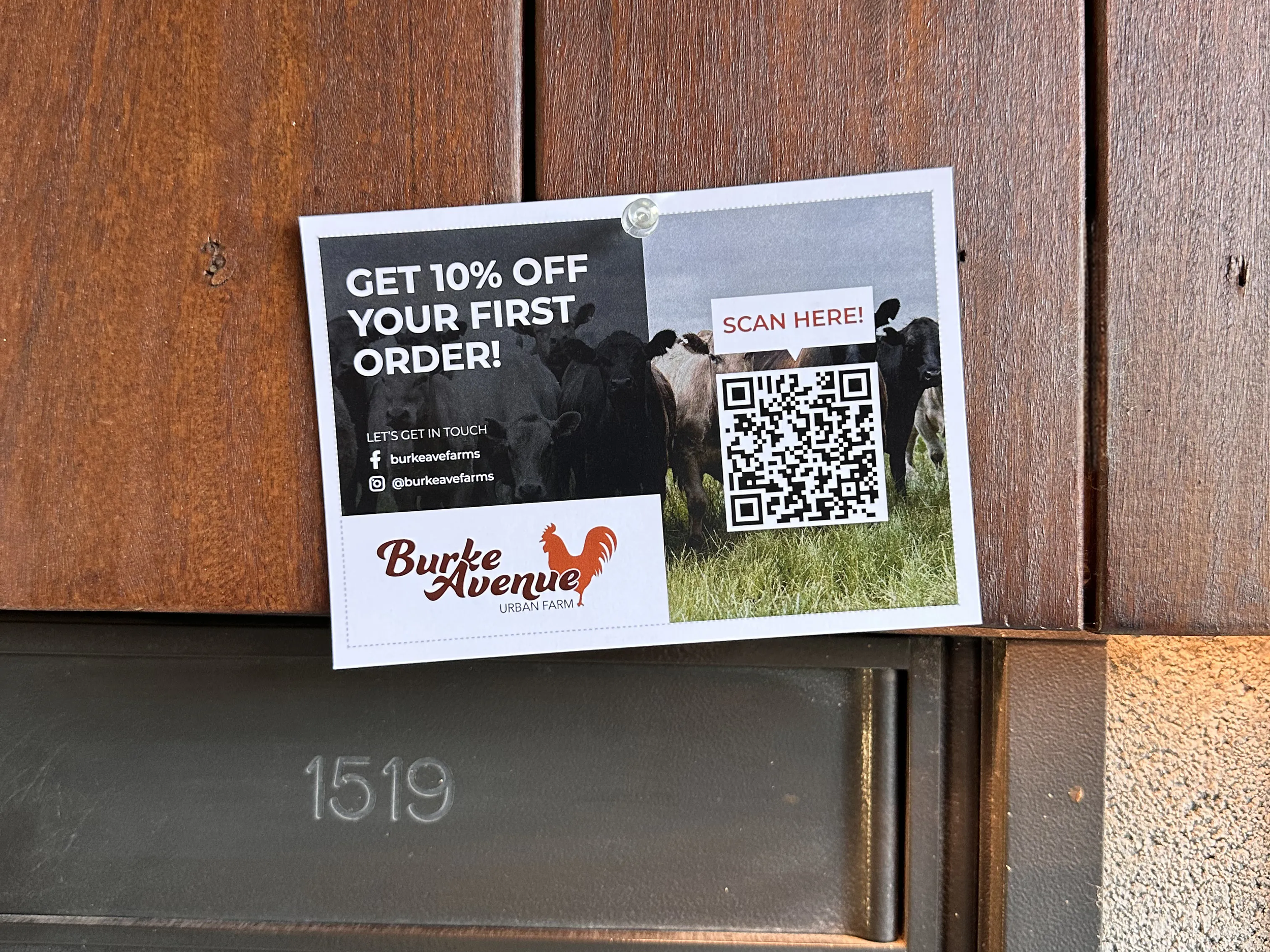 A promotional flyer for Burke Avenue Urban Farm pinned above metal mailboxes.
