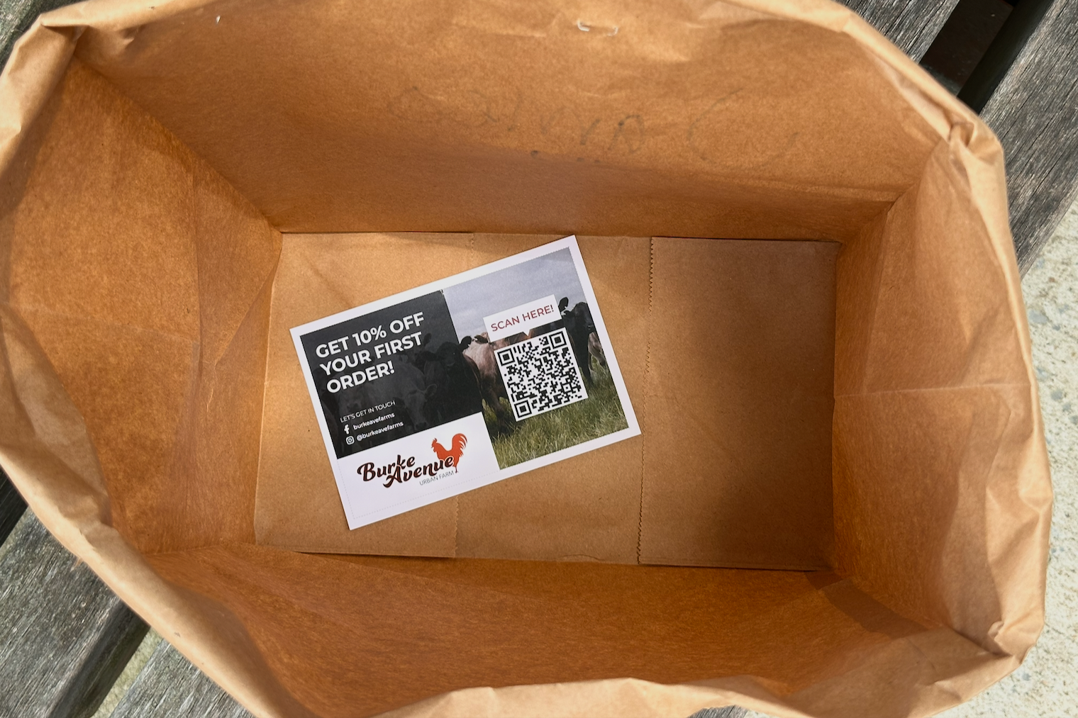 A branded flyer at the bottom of a takeout bag