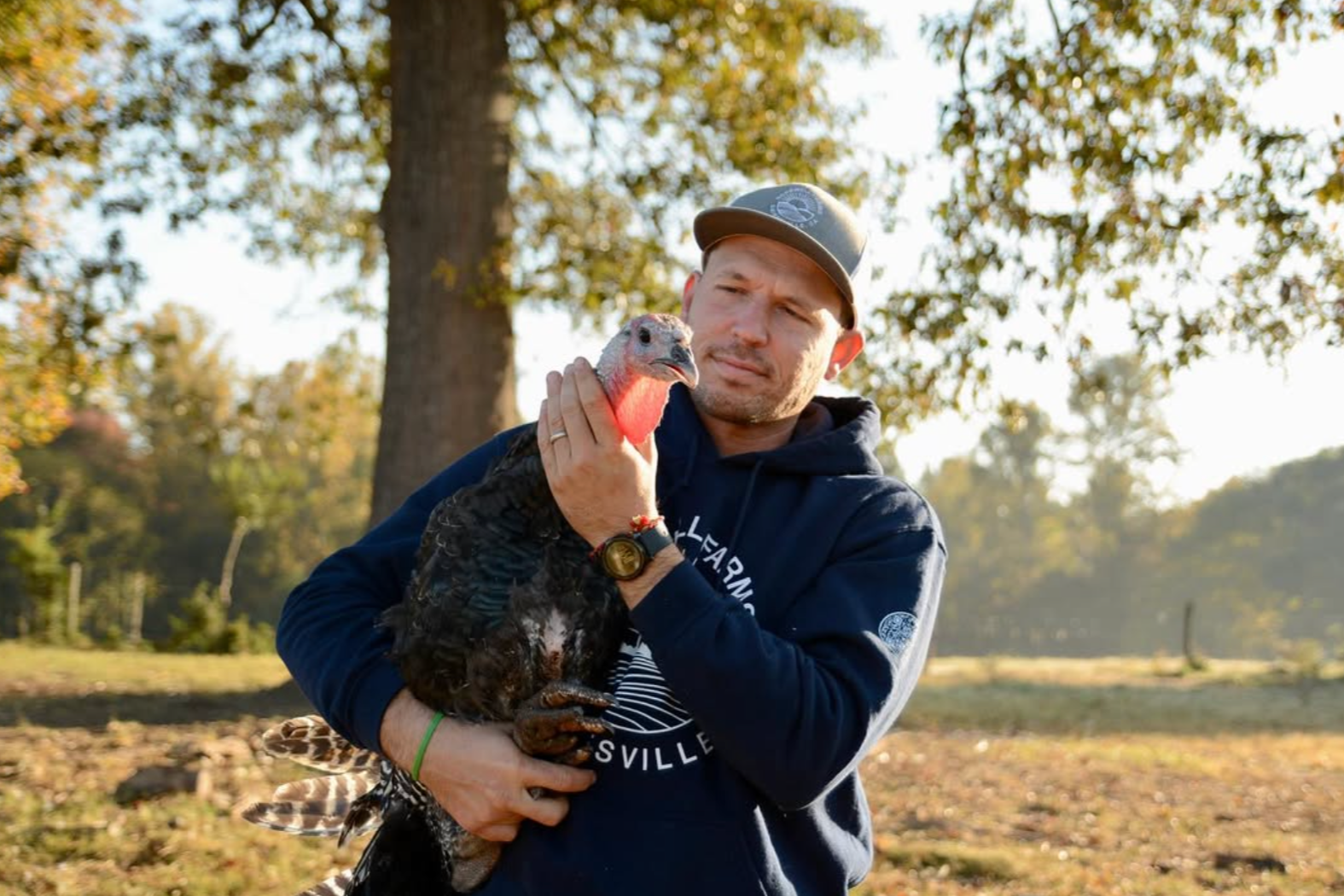 A local farmer holding a turkey