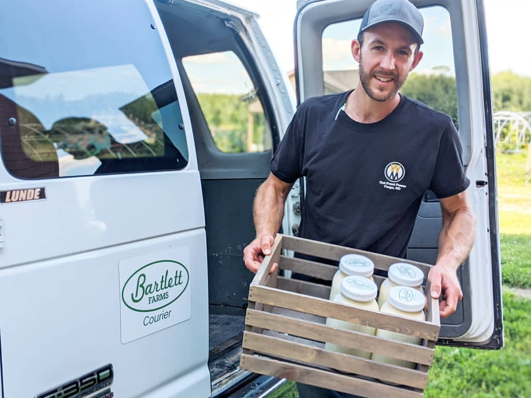 A farmer delivering raw milk to his customers