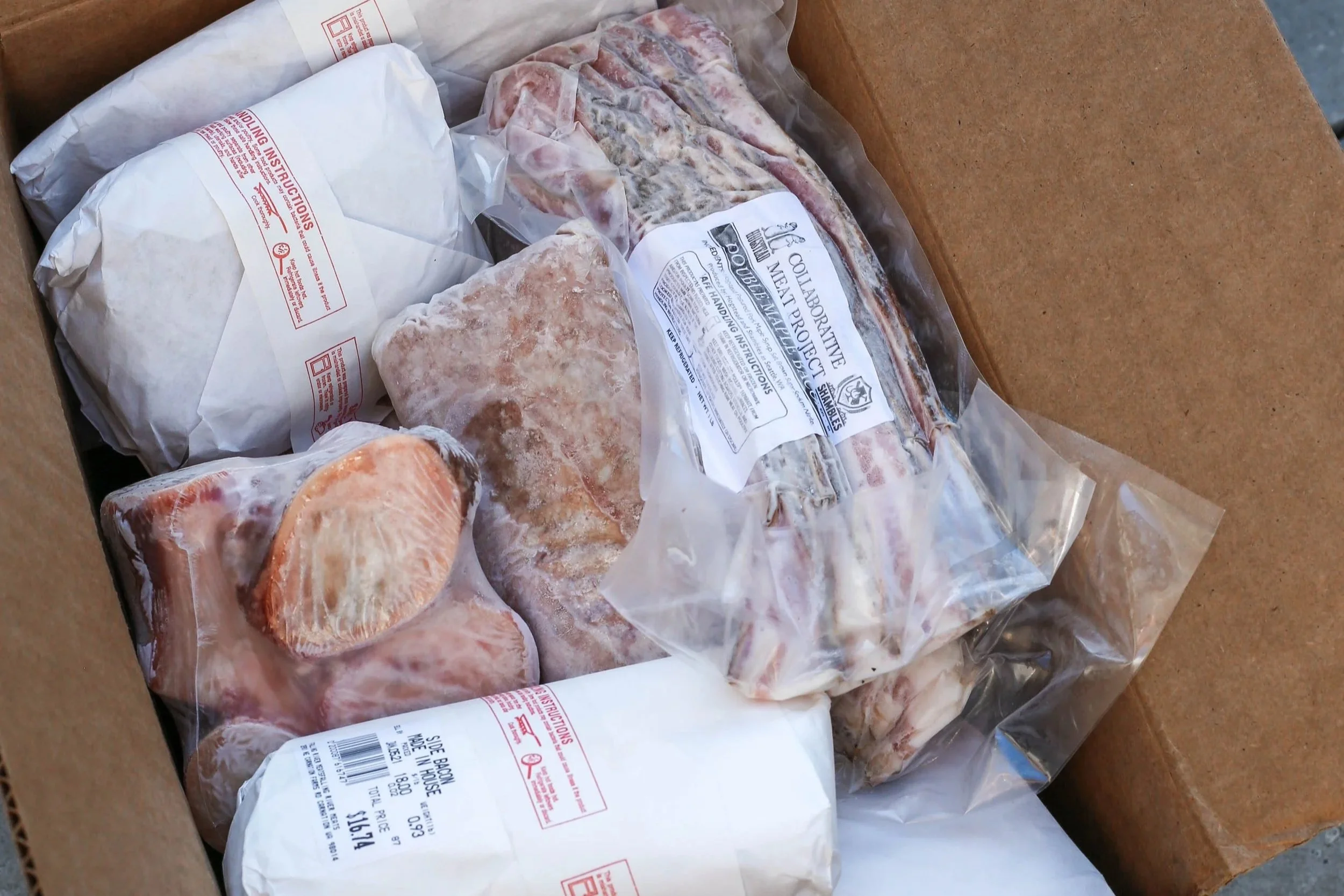 A bundle box full of farm fresh meat products.