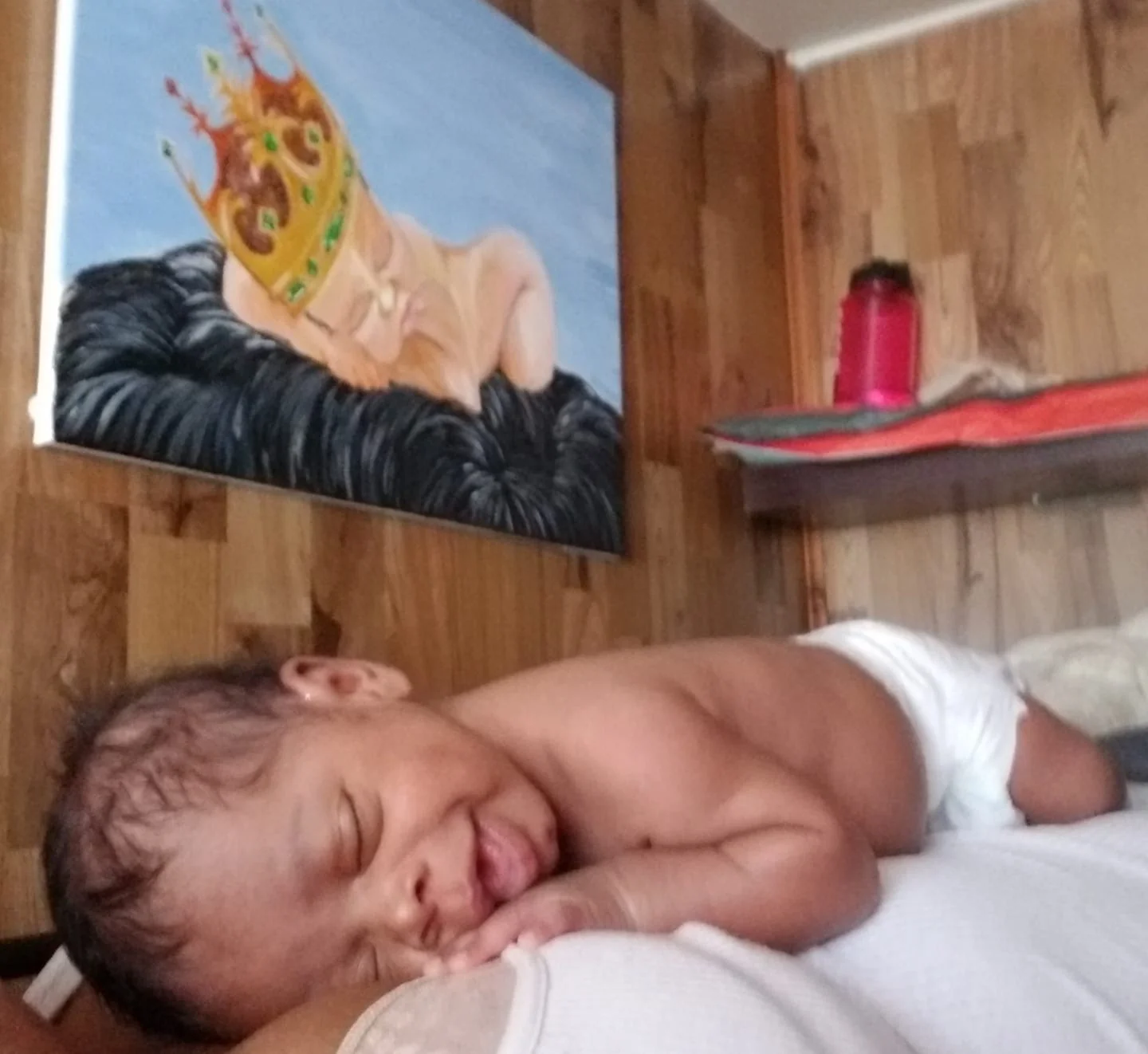 My Godson laying is his room with the Original painting in the background.