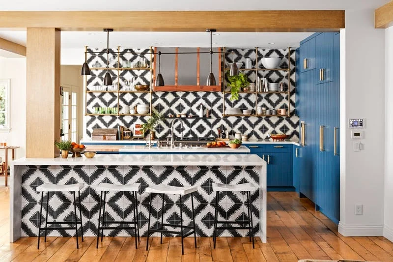 Blue cabinets and graphic black and white tiles make the kitchen of Hilary Duff extra popping | photos by Justin Coit