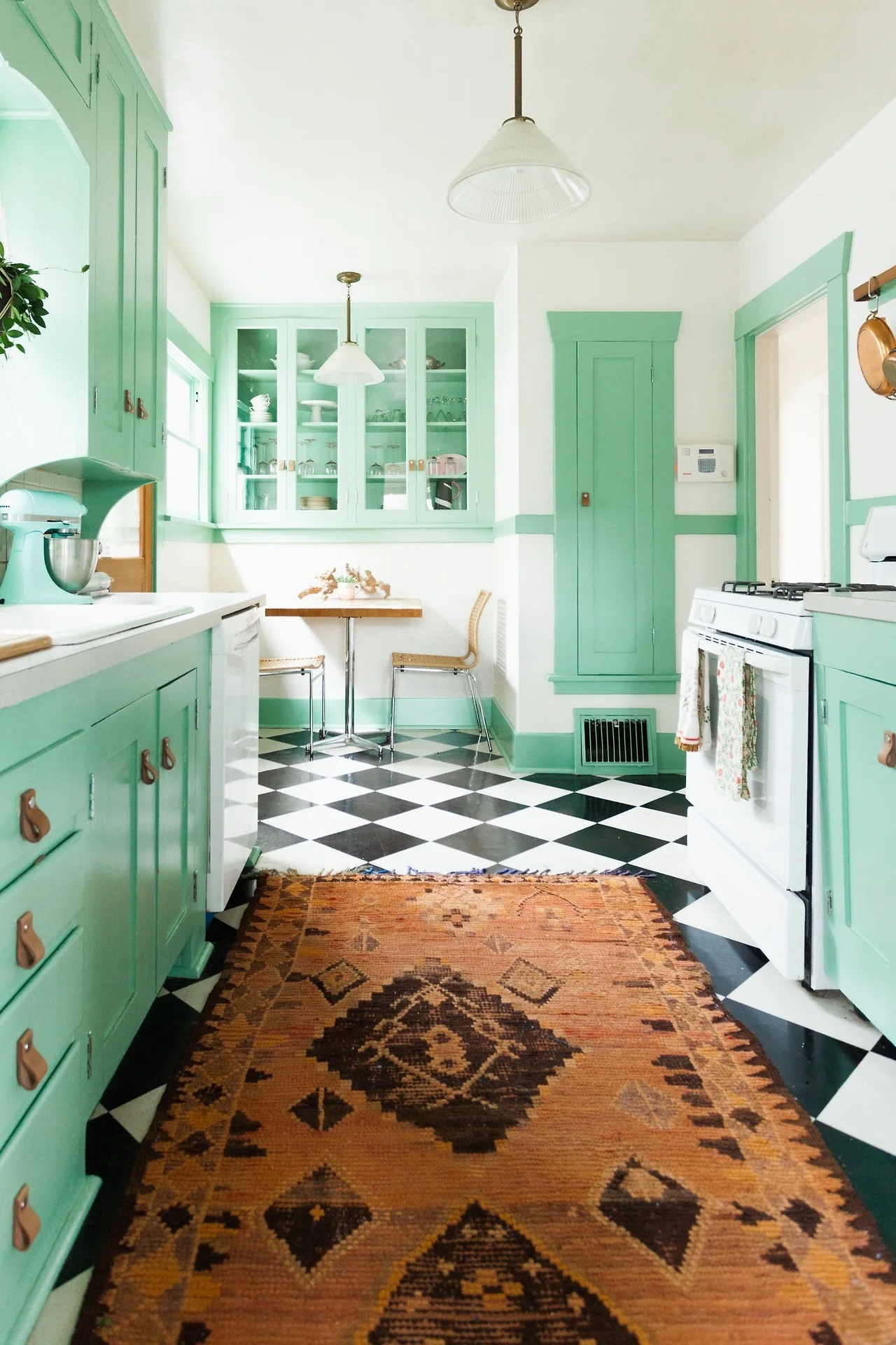 Mint green and black & white checker tiles certainly make for a eye catching combination. I love the little details with the leather handgrips | photo by Ellie Arciaga Lillstrom