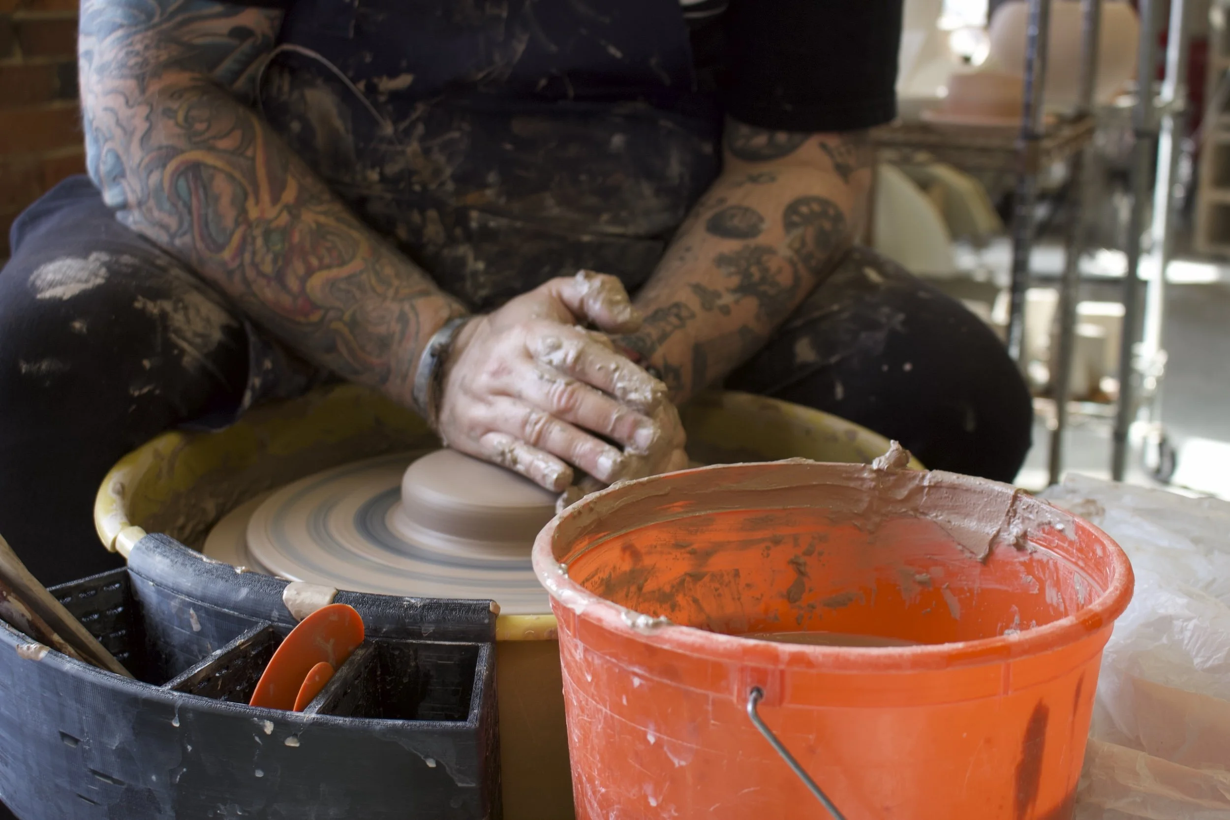 wheel throwing in ceramics studio.