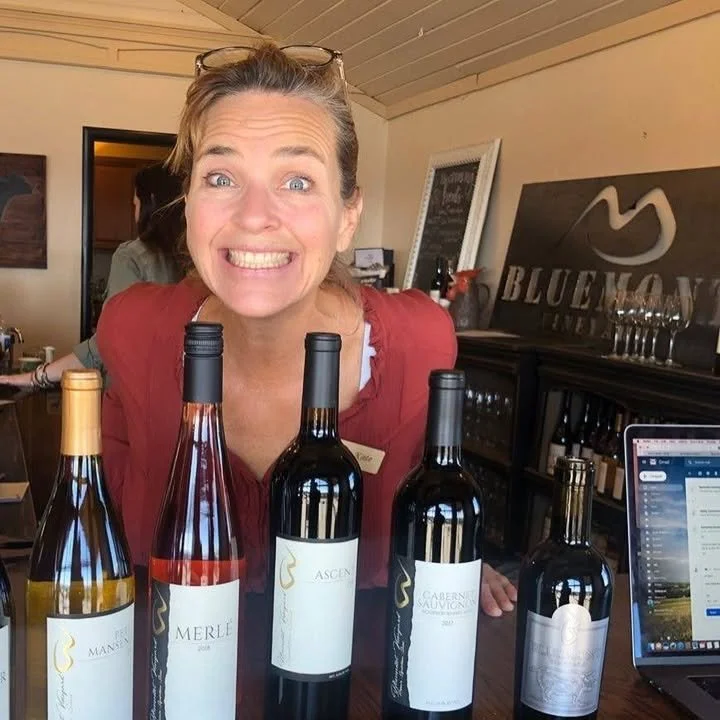 KAte with wine bottles.jpeg