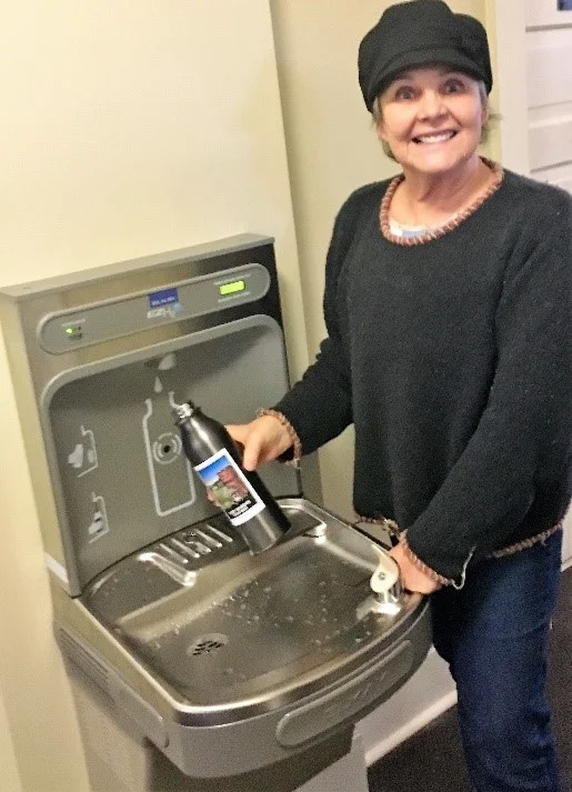 FFW Gift Shop Manager Lindy Adelmann at the new water bottle filling station in Building 200