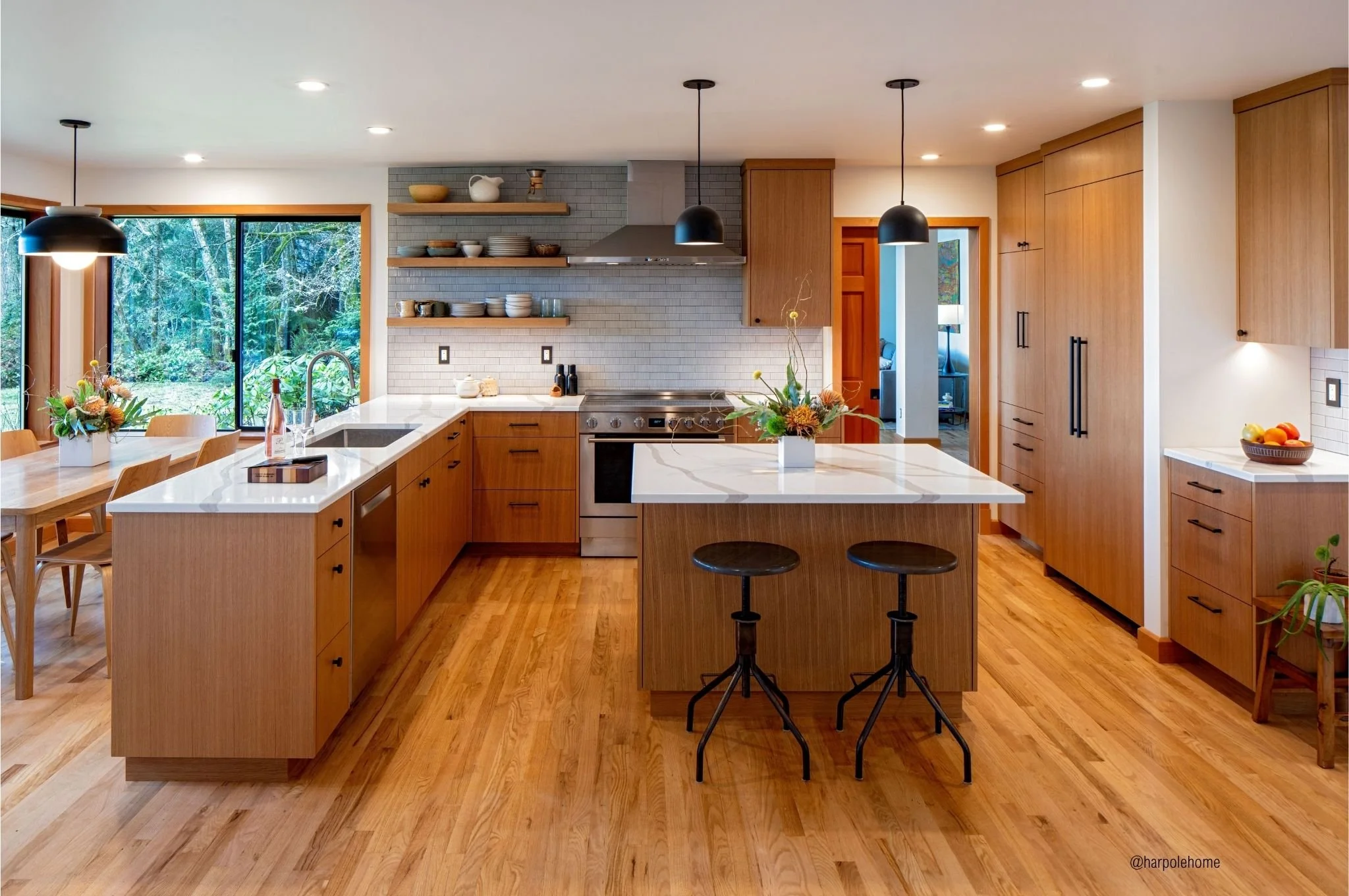 Vashon Island kitchen remodel with custom oak cabinetry, oversized island, and forest views