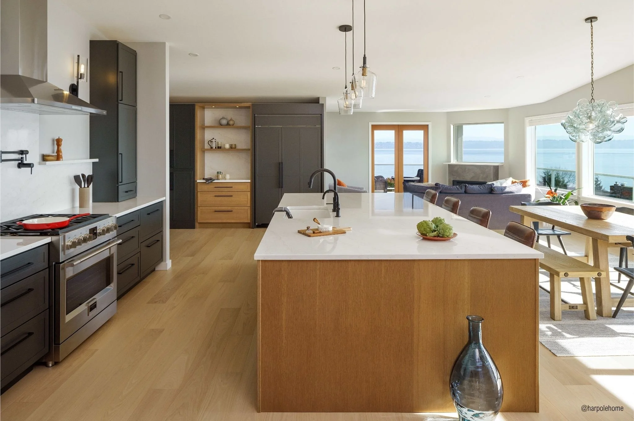 Vashon Island kitchen remodel with Dura Supreme two-tone cabinetry, oversized island, and Puget Sound views