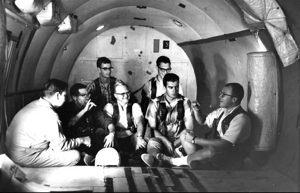 Study participants chat in the zero-g aircraft that flew out of Naval Air Station in Pensacola, Fla. Credits: U.S. Navy/Gallaudet University collection