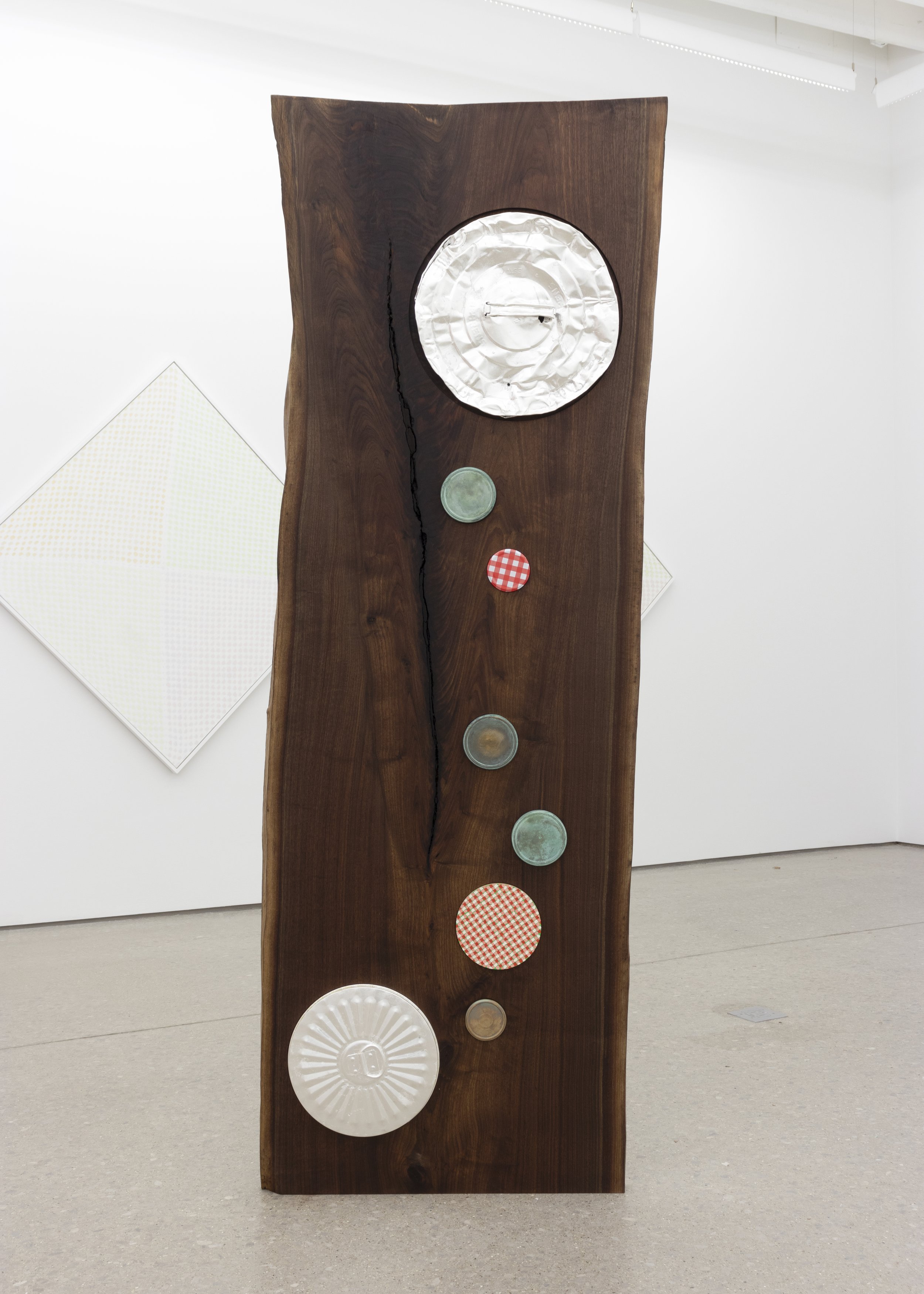   Untitled , 2022   oil on panel, silver on steel, found jam jar lid and bronze on walnut   86 x 31 x 3 in 